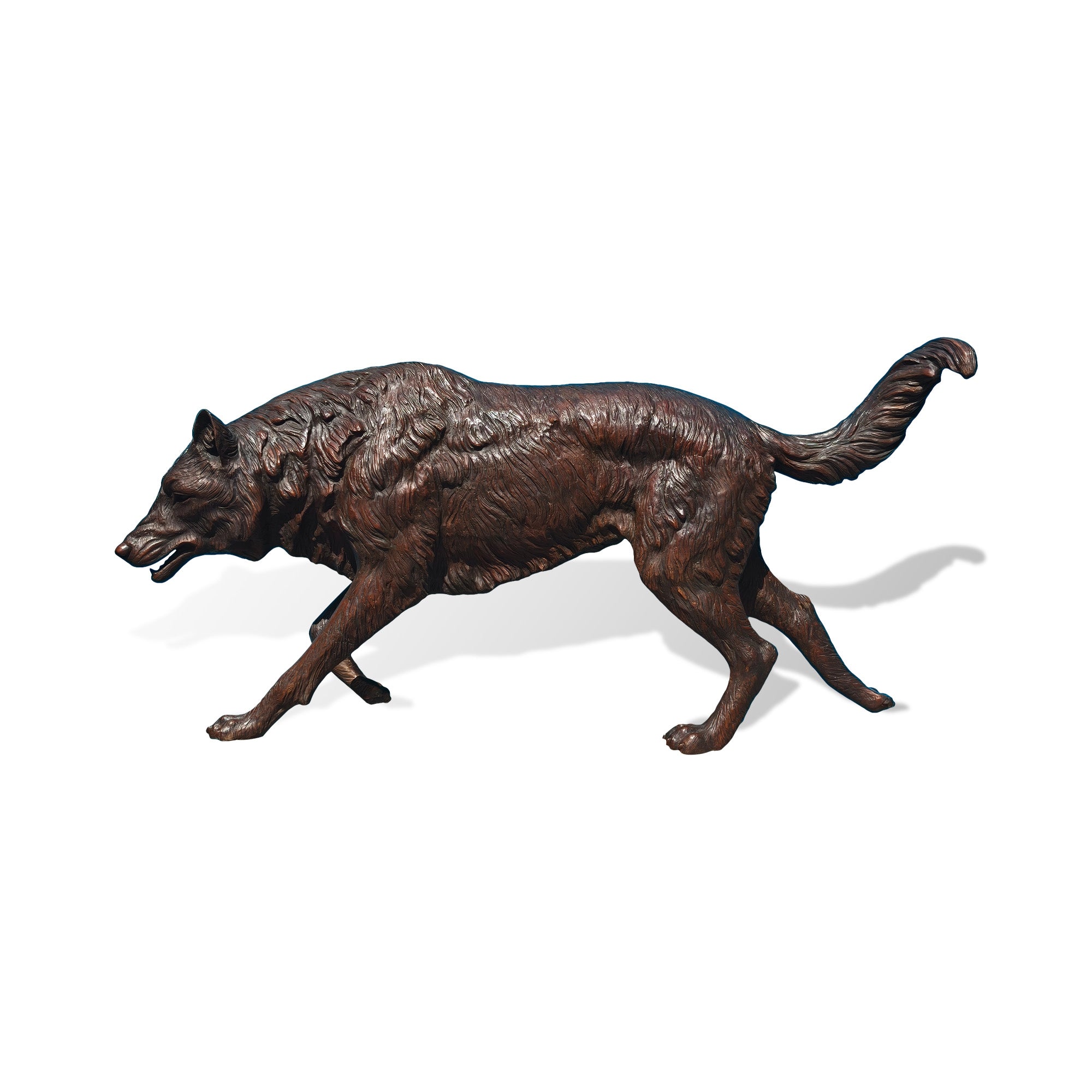 Realistic bronze wolf sculpture in walking pose, featuring detailed fur texture, powerful body form, curved tail, and handcrafted wildlife animal statue design.