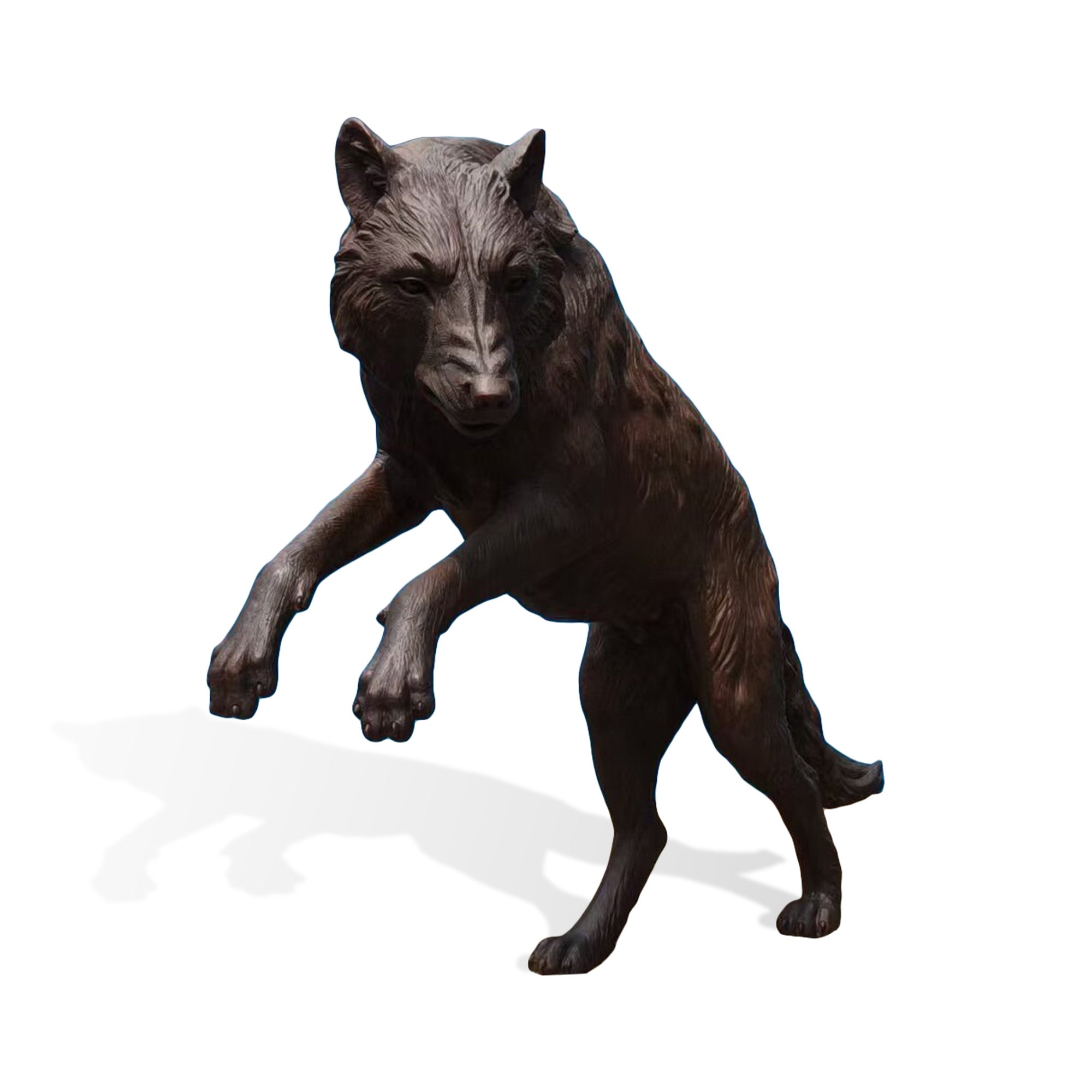 Front view of a leaping bronze wolf sculpture with realistic facial details, textured fur surface, raised paws, and handcrafted outdoor animal artwork.