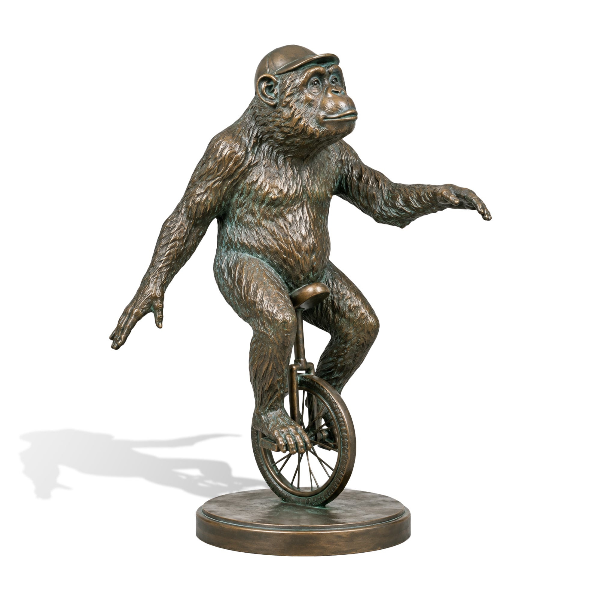 Bronze monkey riding a unicycle sculpture with extended arms and a playful balancing pose, featuring realistic facial details, deeply textured fur, a round base, and aged verdigris patina finish.