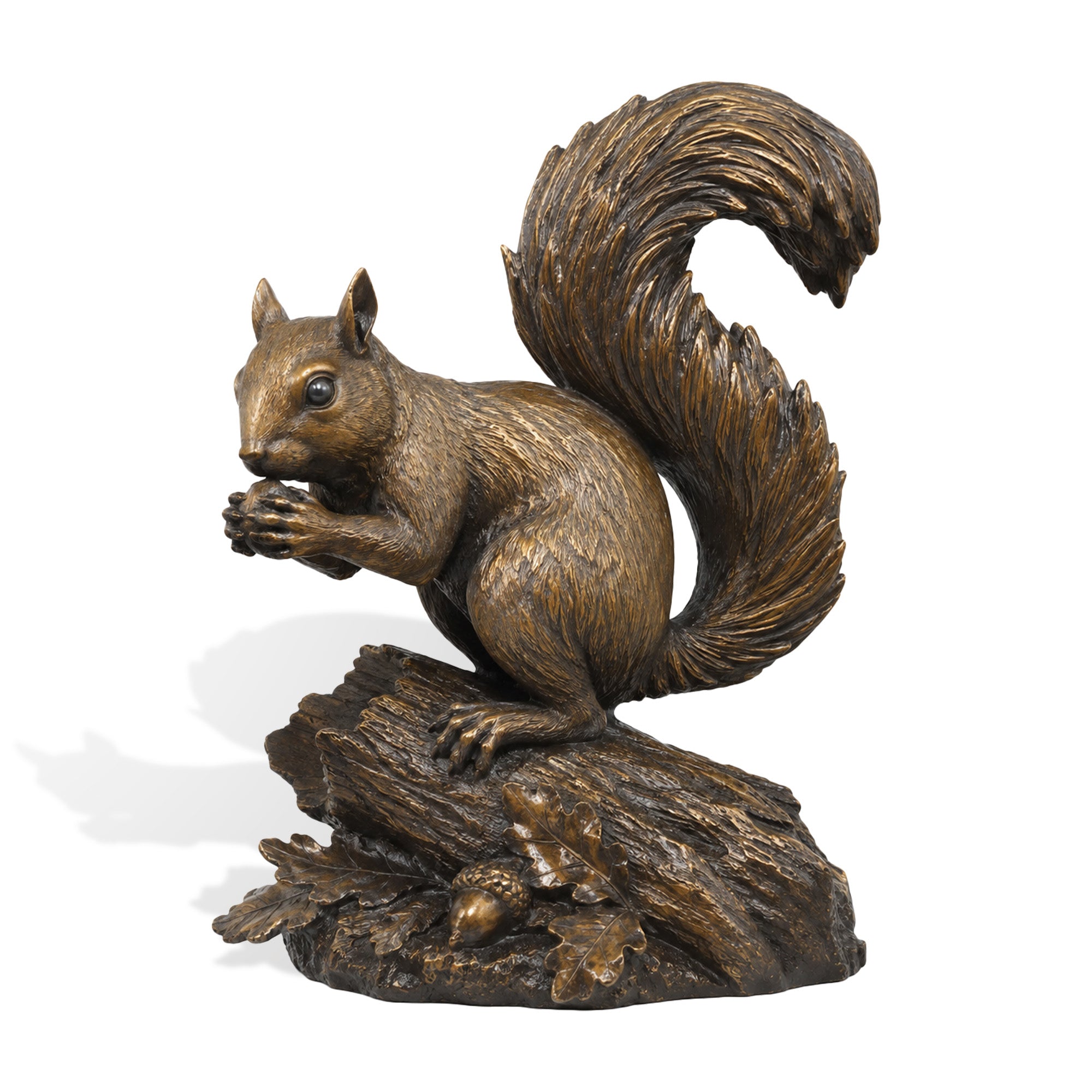 Bronze squirrel sculpture showing a lifelike squirrel holding an acorn on a textured log, with detailed fur, a large curled tail, oak leaves, and an antique bronze finish.