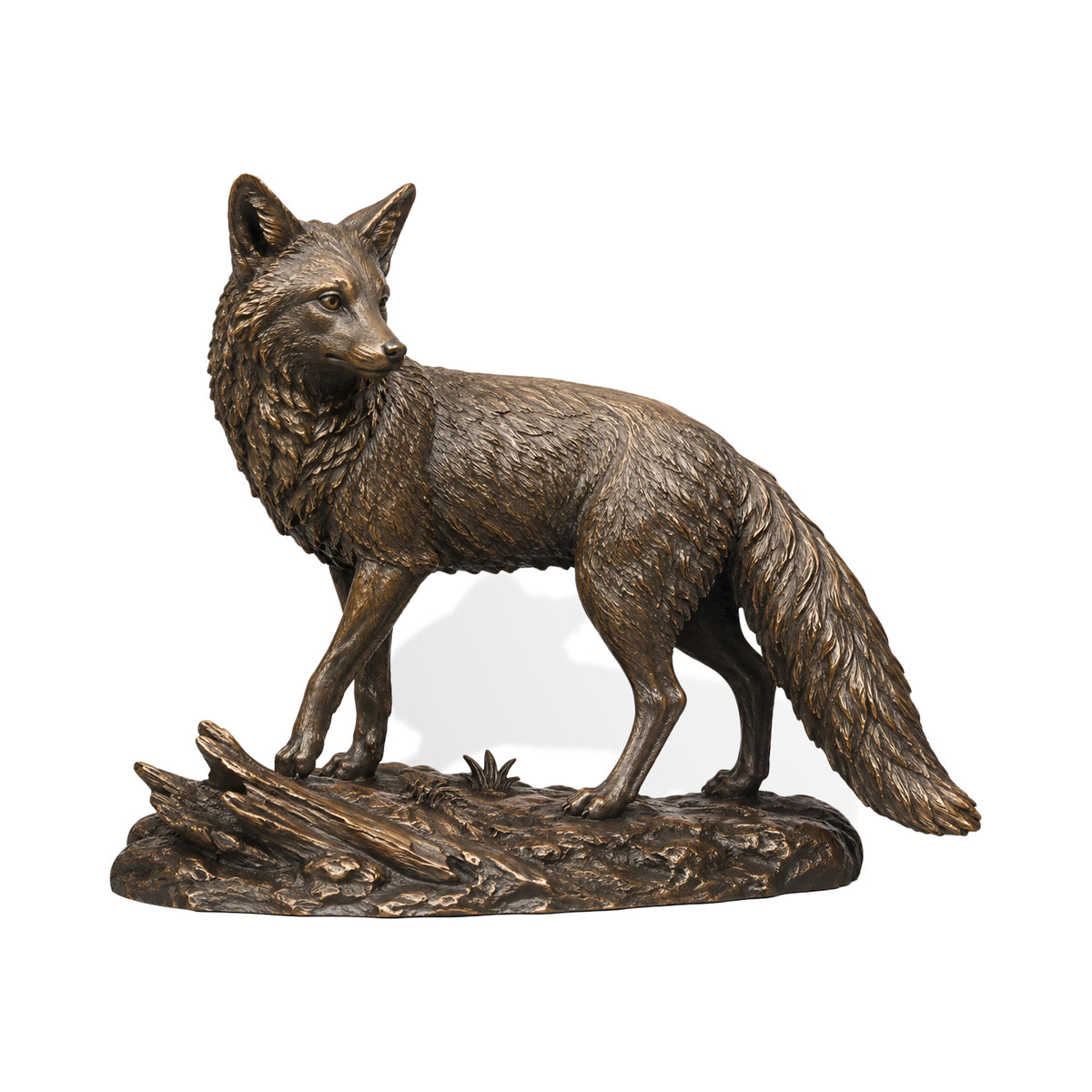 Lifelike bronze fox sculpture standing alert on a textured woodland base, featuring finely modeled fur, pointed ears, a long bushy tail, natural ground details, and a warm antique bronze finish.