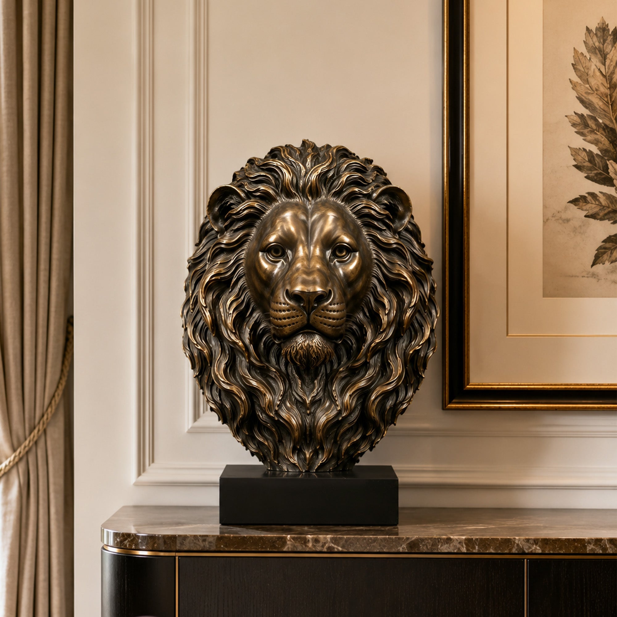 Majestic bronze lion head sculpture displayed on a black rectangular pedestal in an elegant interior, featuring a symmetrical face, deeply sculpted flowing mane, realistic facial details, and a warm antique bronze finish with golden highlights.