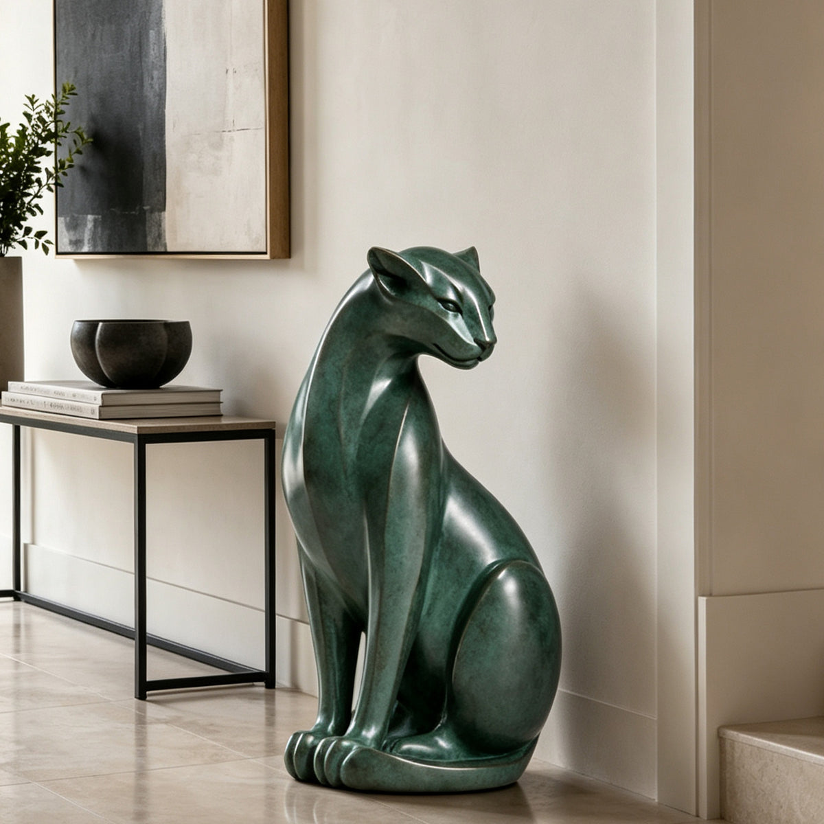 Modern seated bronze panther sculpture with green patina displayed in a minimalist luxury home interior