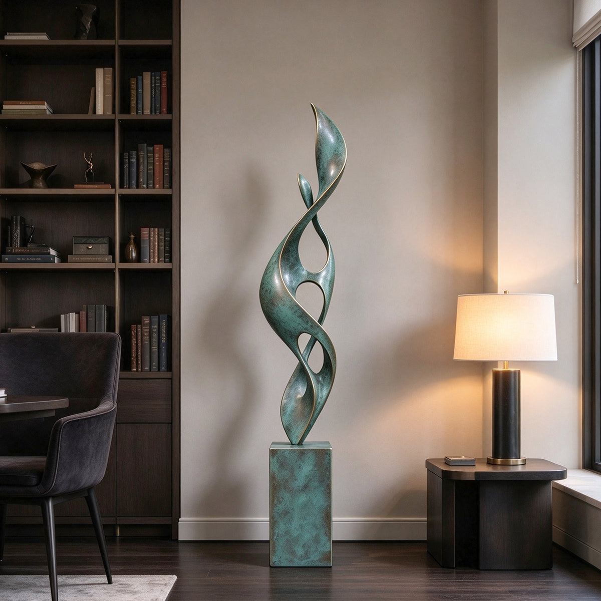 Tall abstract bronze sculpture with twisting leaf-like curves, open spaces and green patina displayed in a modern luxury interior beside a bookshelf.