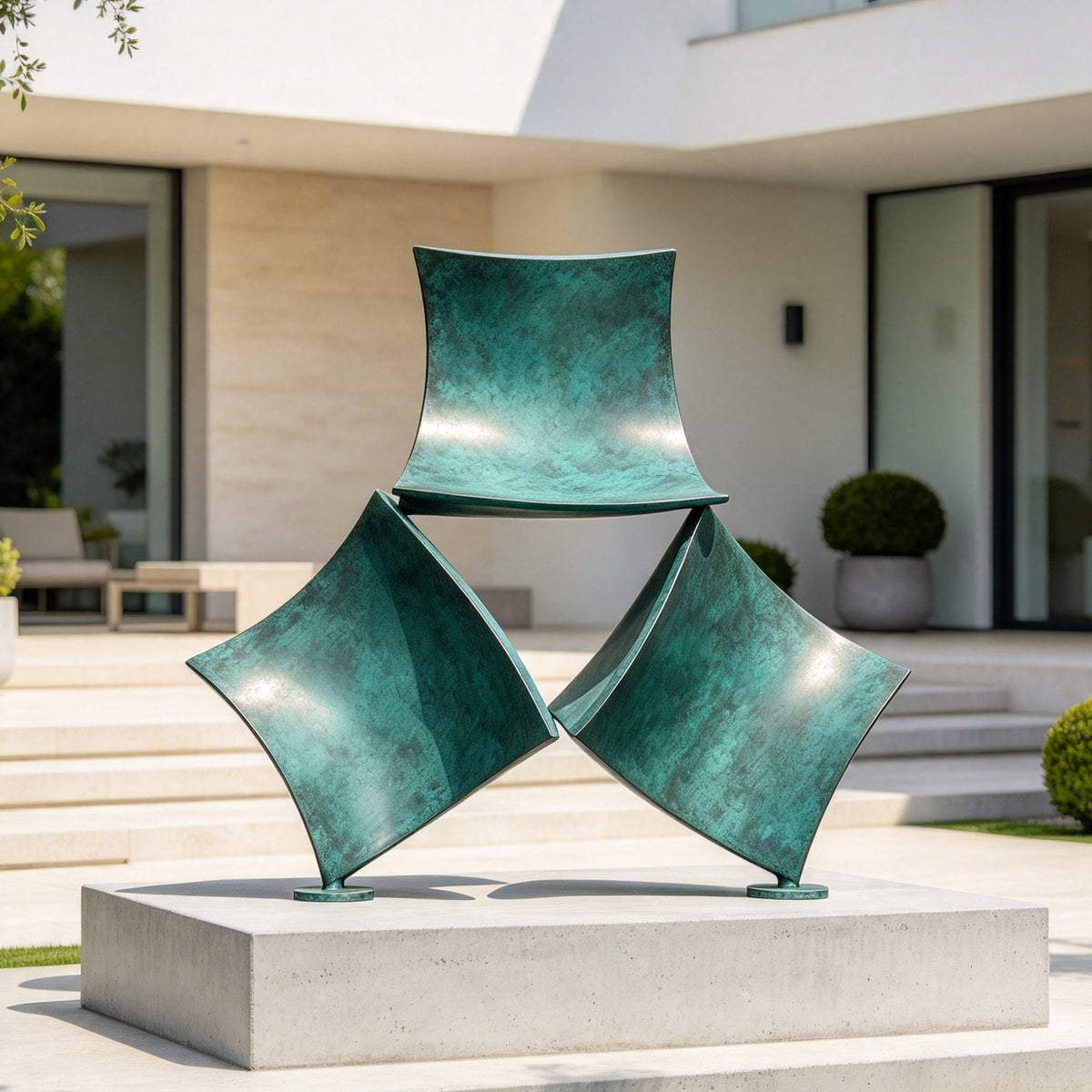 Turquoise patinated bronze abstract sculpture displayed on a stone platform in a modern architectural courtyard with pale walls and minimalist landscaping.