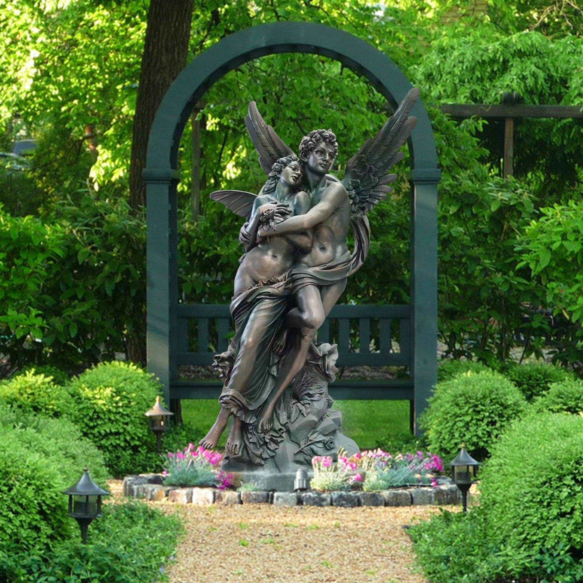 coppery color Cupid and Psyche fiberglass sculpture in garden