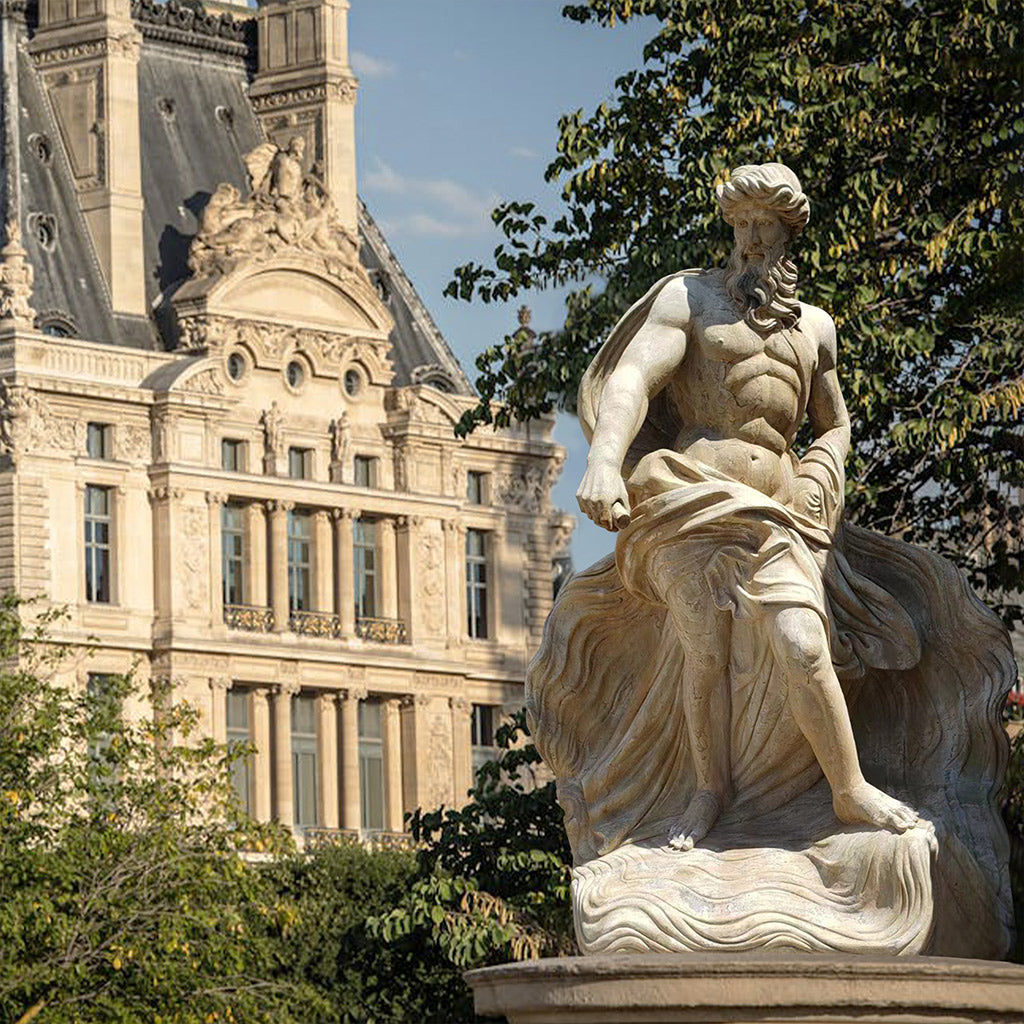  Life-size marble statue of Neptune/Poseidon in a dynamic pose with flowing robes, set in an outdoor classical architectural setting.