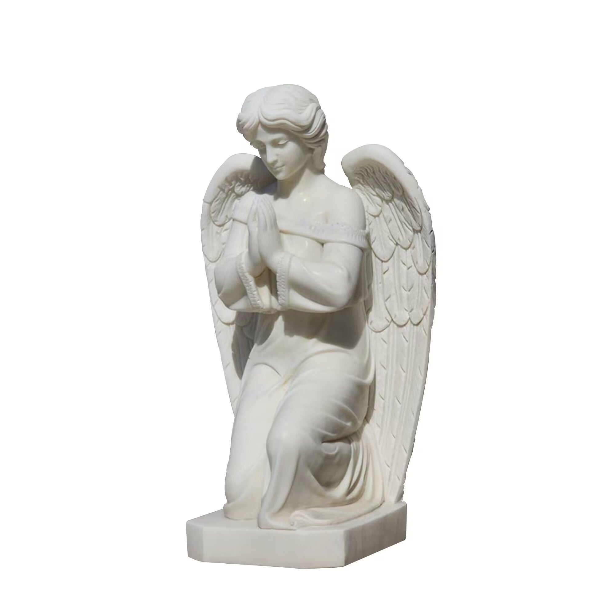 Marble statue of a kneeling angel in prayer with folded wings