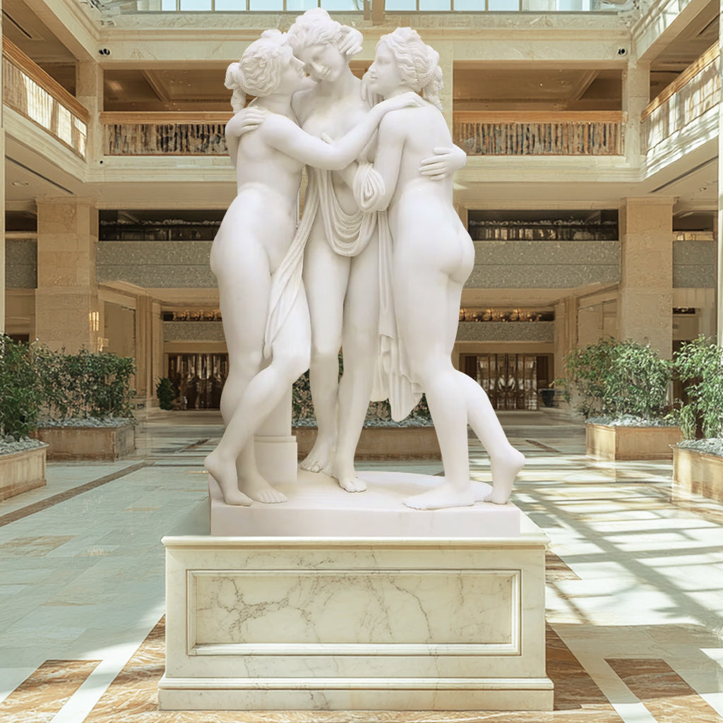 Custom White Marble Garden Sculpture of The Three Graces, featuring graceful figures in a polished finish, display in a indoor lobby