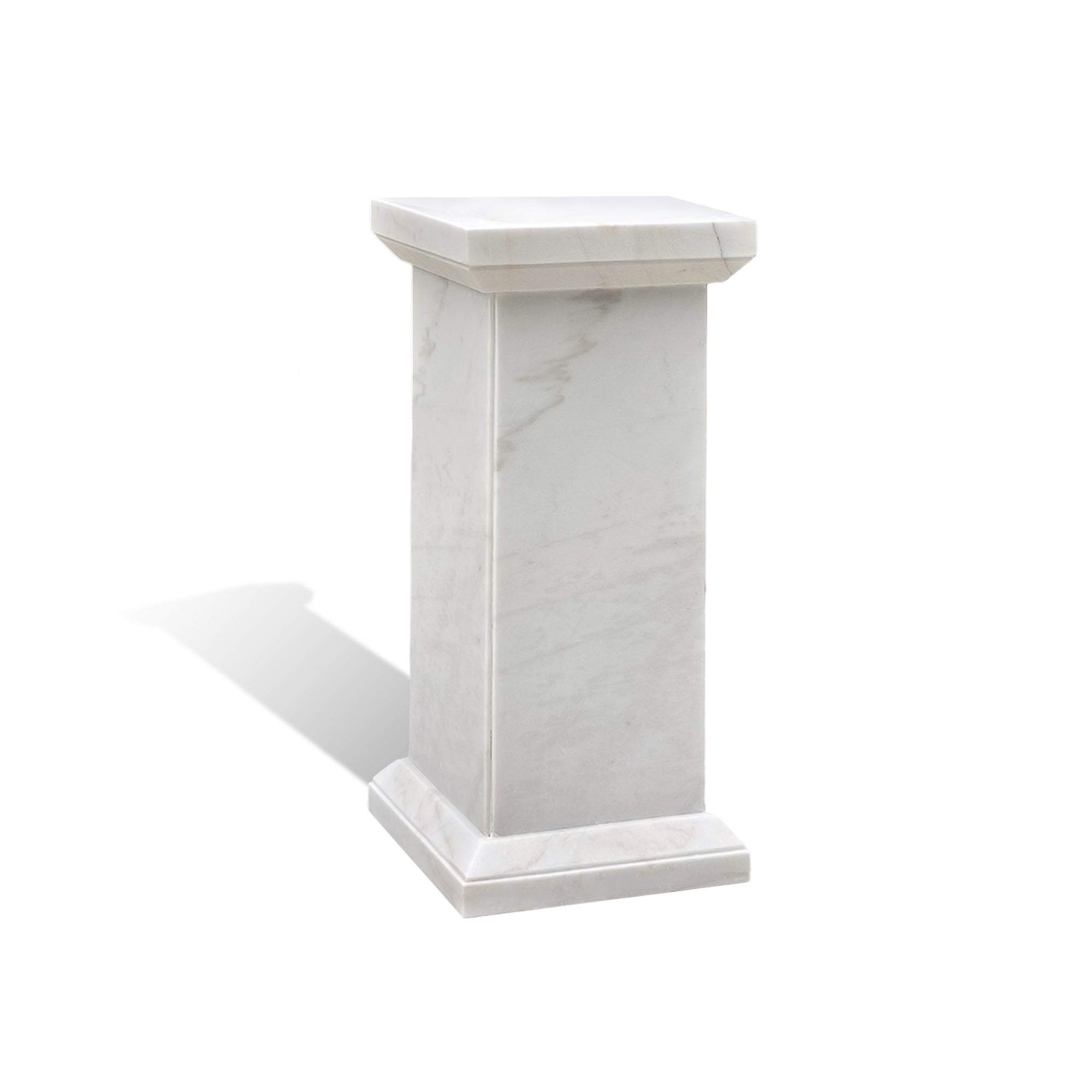 Hand-carved marble plinth serving as a stable outdoor sculpture base