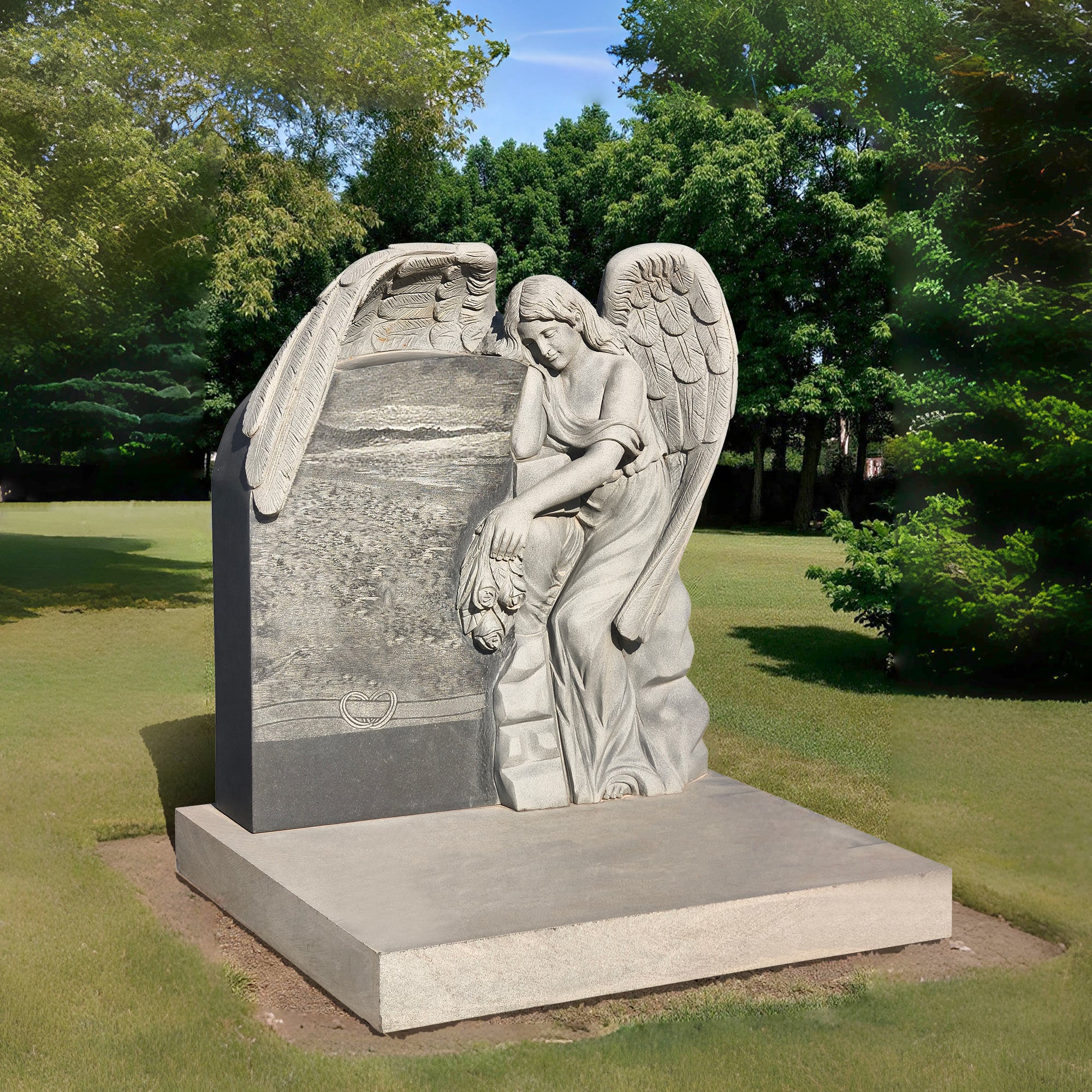 grey granite angel headstone in cemetery setting with carved angel leaning on the gravestone, holding roses as a symbol of love and eternal remembrance