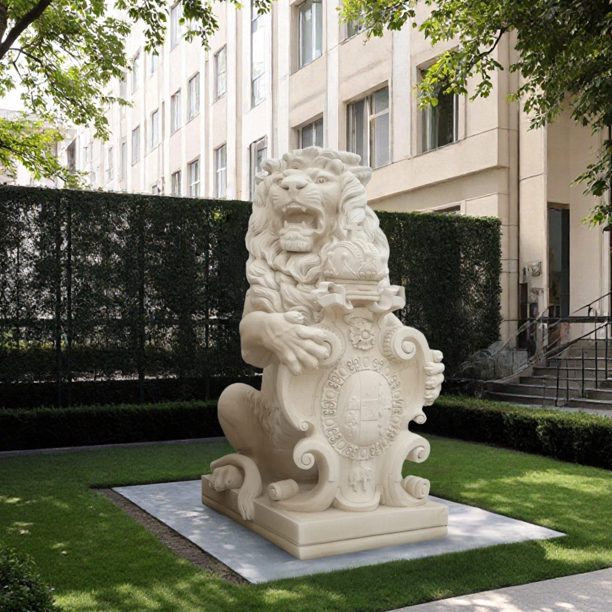 Full view of the lion sculpture, featuring the lion seated on a pedestal with an intricate family crest, set in a green garden with surrounding trees.