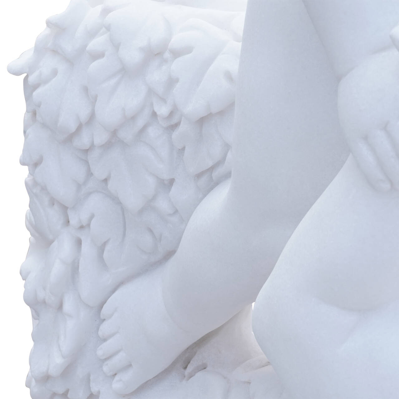 close-up of vine leaf motif with cherub foot in white marble, elegant hand-carved decorative detail from a classical marble sculpture.