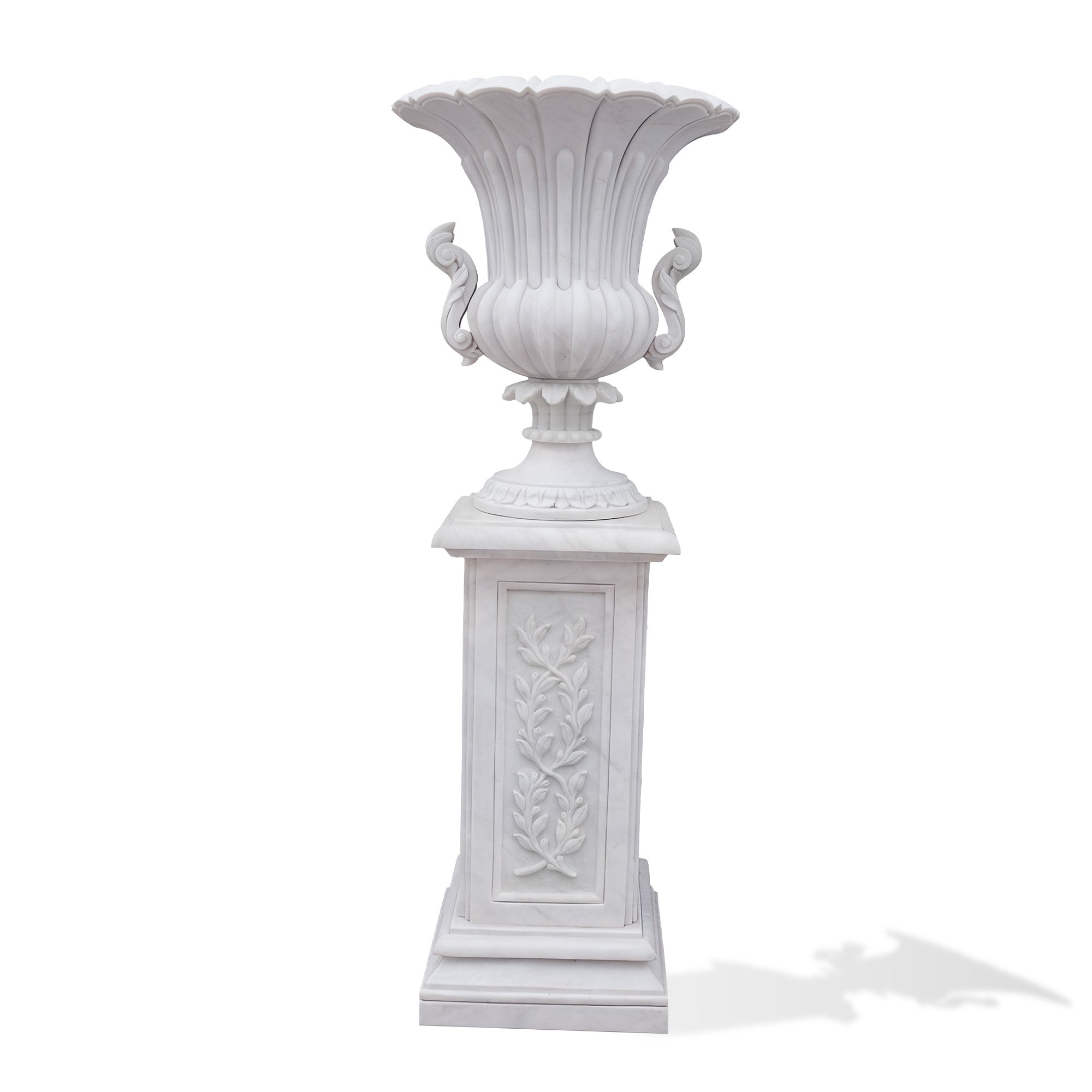 White marble flower vase with carved floral design and decorative pedestal, bringing sophisticated beauty to gardens and elegant outdoor environments.