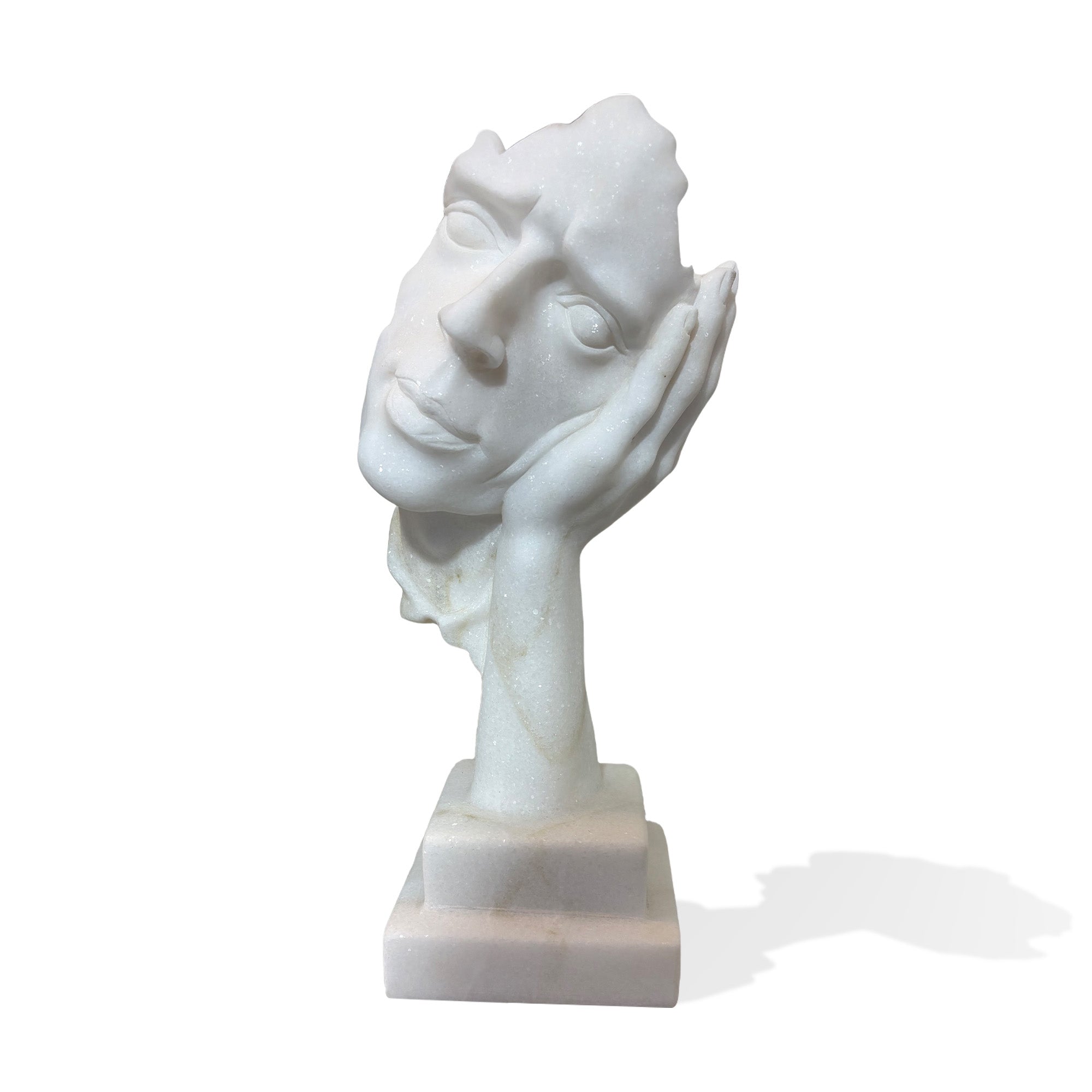 White marble abstract face sculpture with hand support on pedestal base, front view on plain background