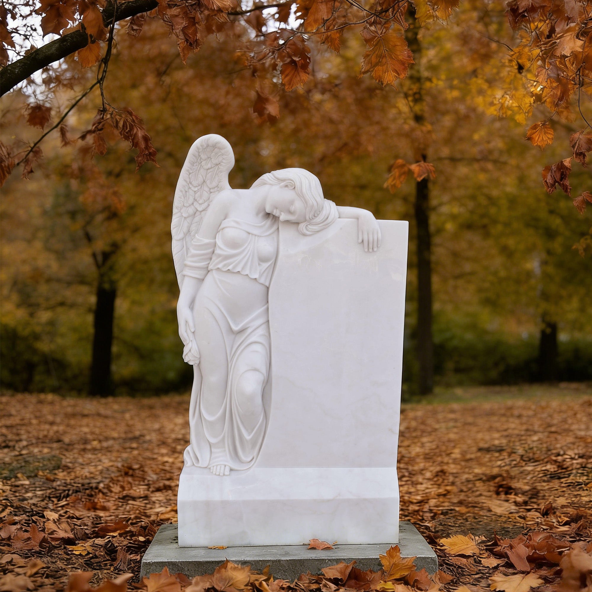 White marble angel headstone memorial monument displayed in a cemetery garden setting