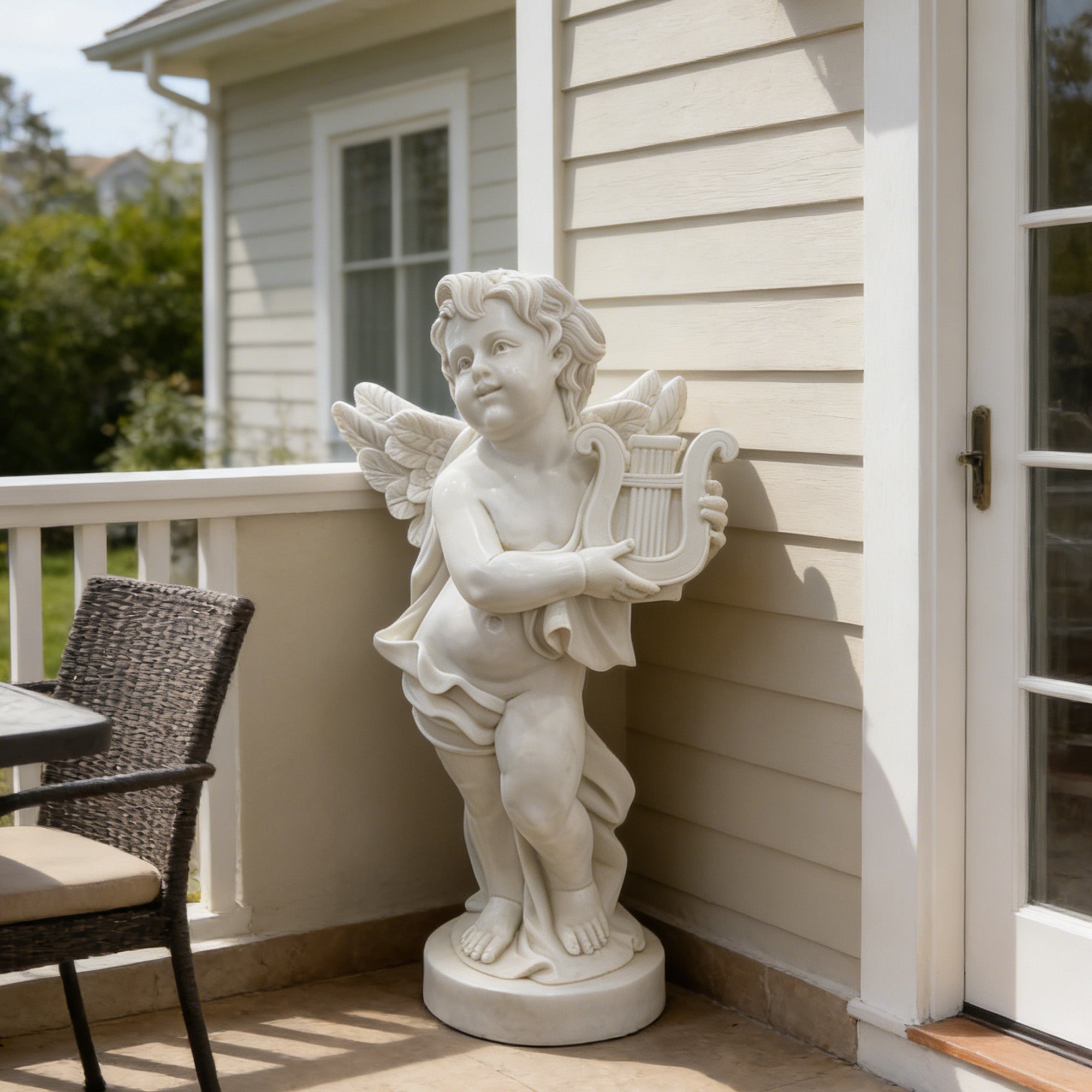 white natural marble cherub statue holding lyre displayed in an outdoor courtyard with stone wall background and classical architectural setting