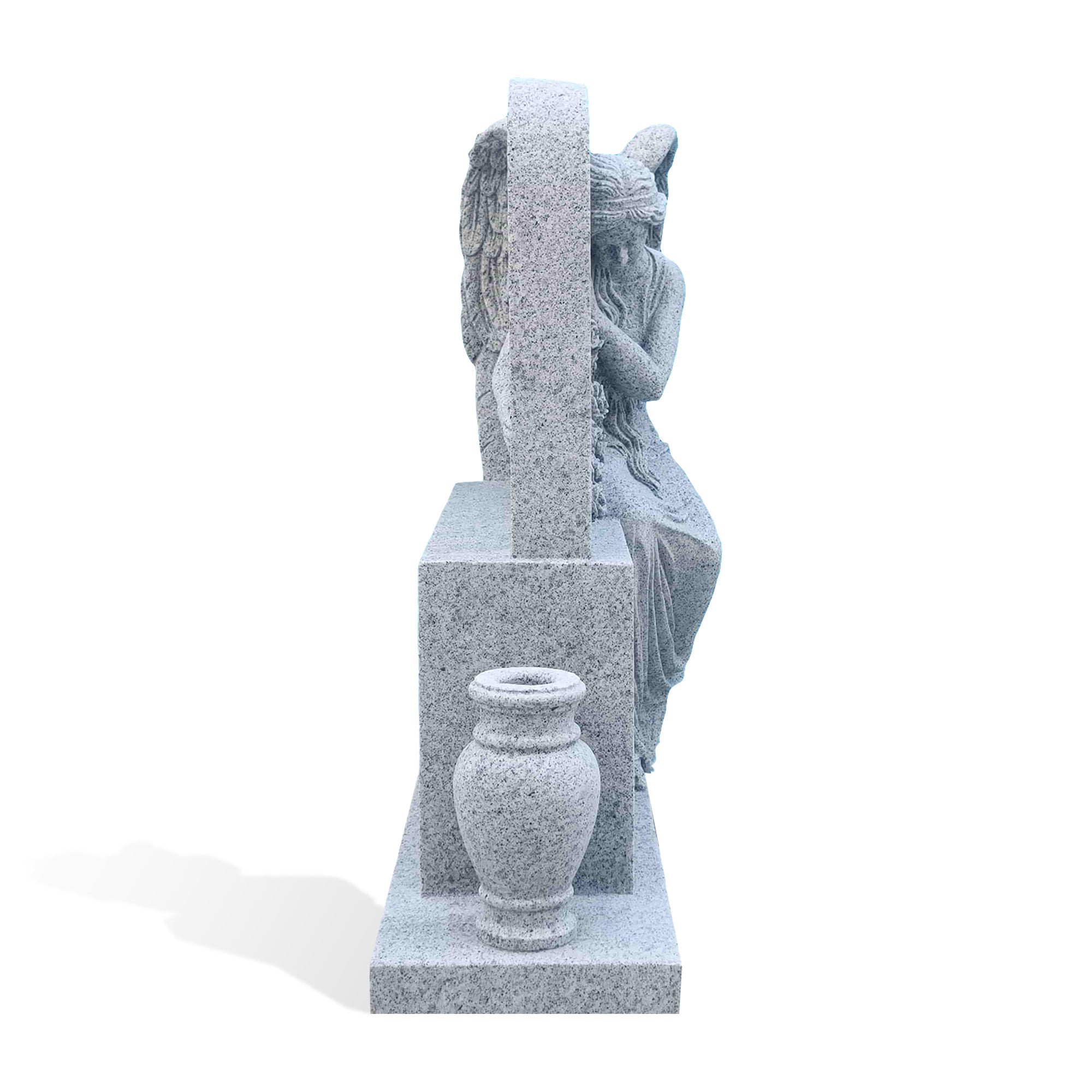 Side view of the grey granite angel headstone showing the monument depth, carved angel profile and matching granite vase