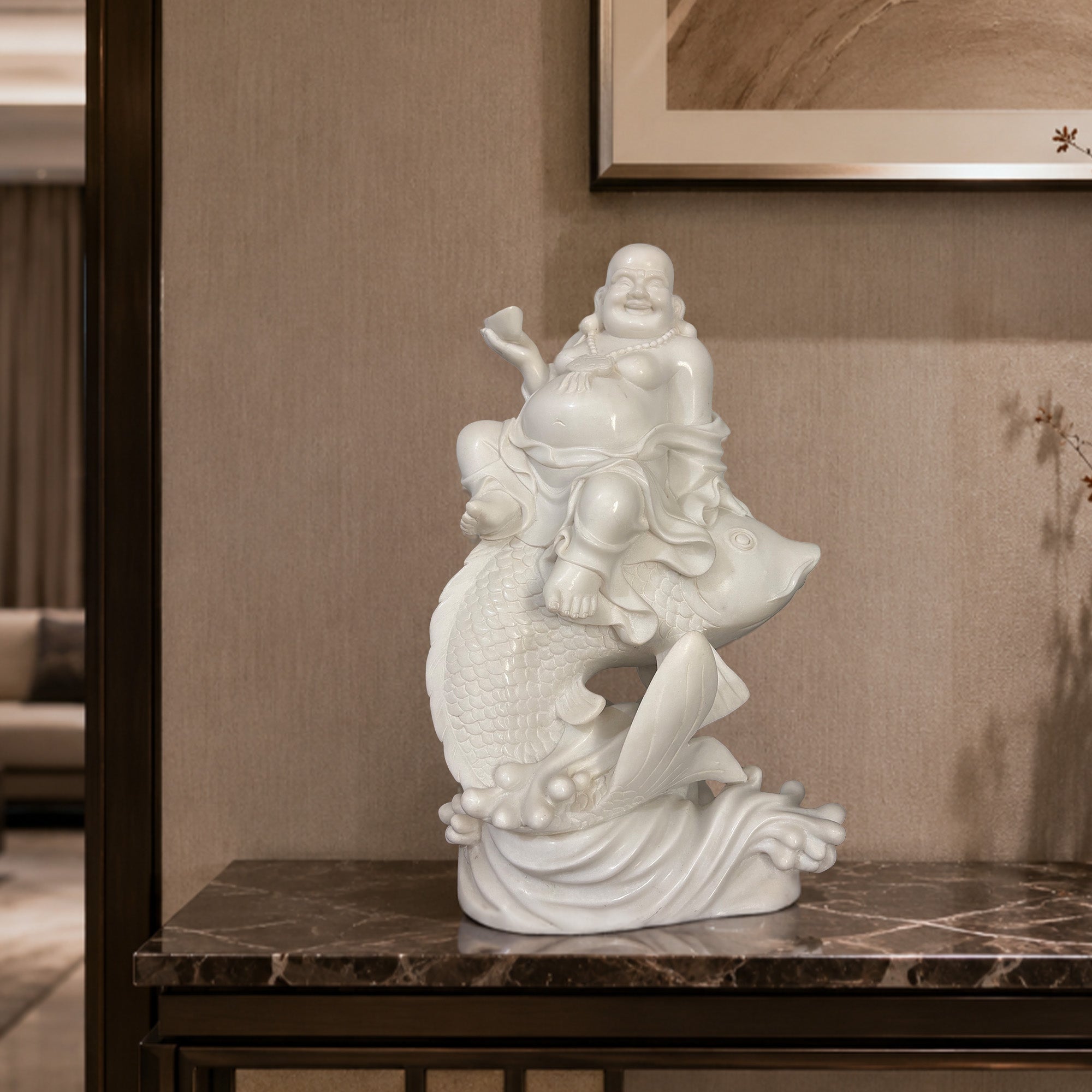 White marble Laughing Buddha riding koi fish displayed on a console table as joyful prosperity decor for a modern foyer