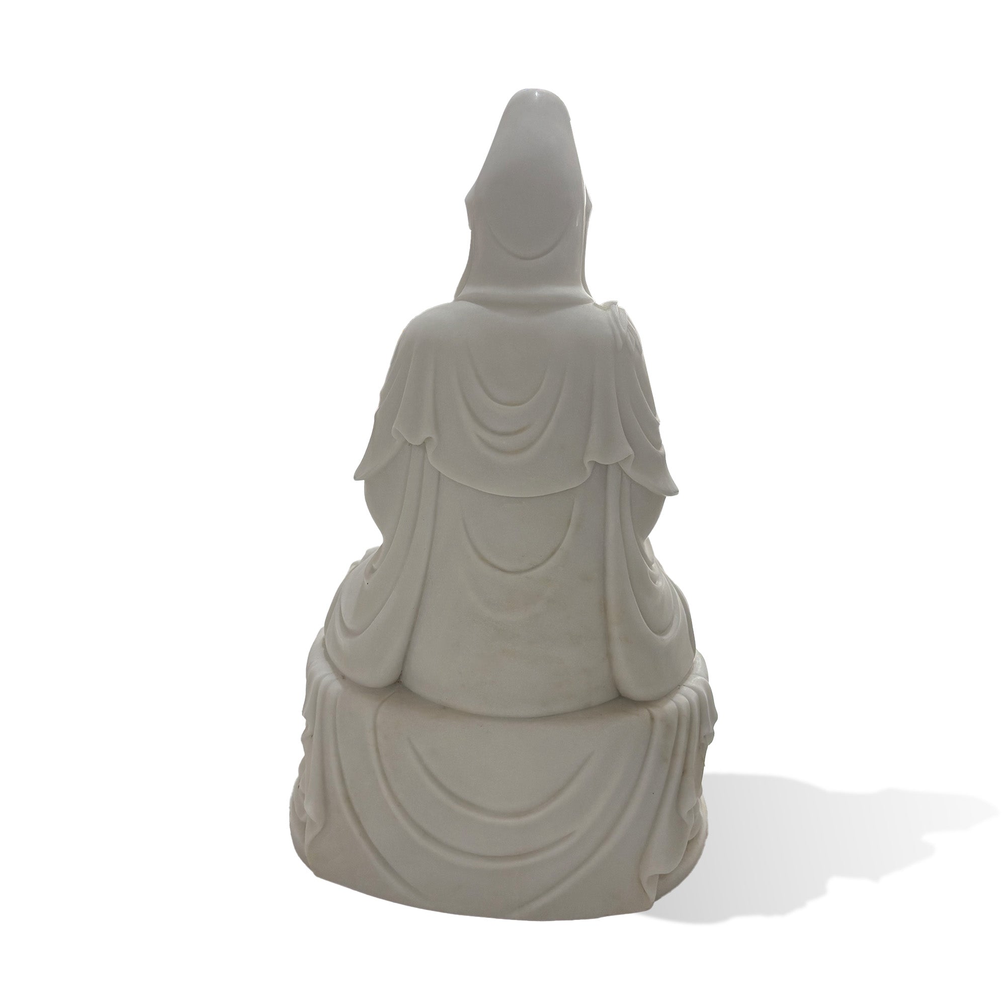 Back view of a natural white marble Guanyin statue showing the carved headdress, flowing robe layers, and lotus pedestal