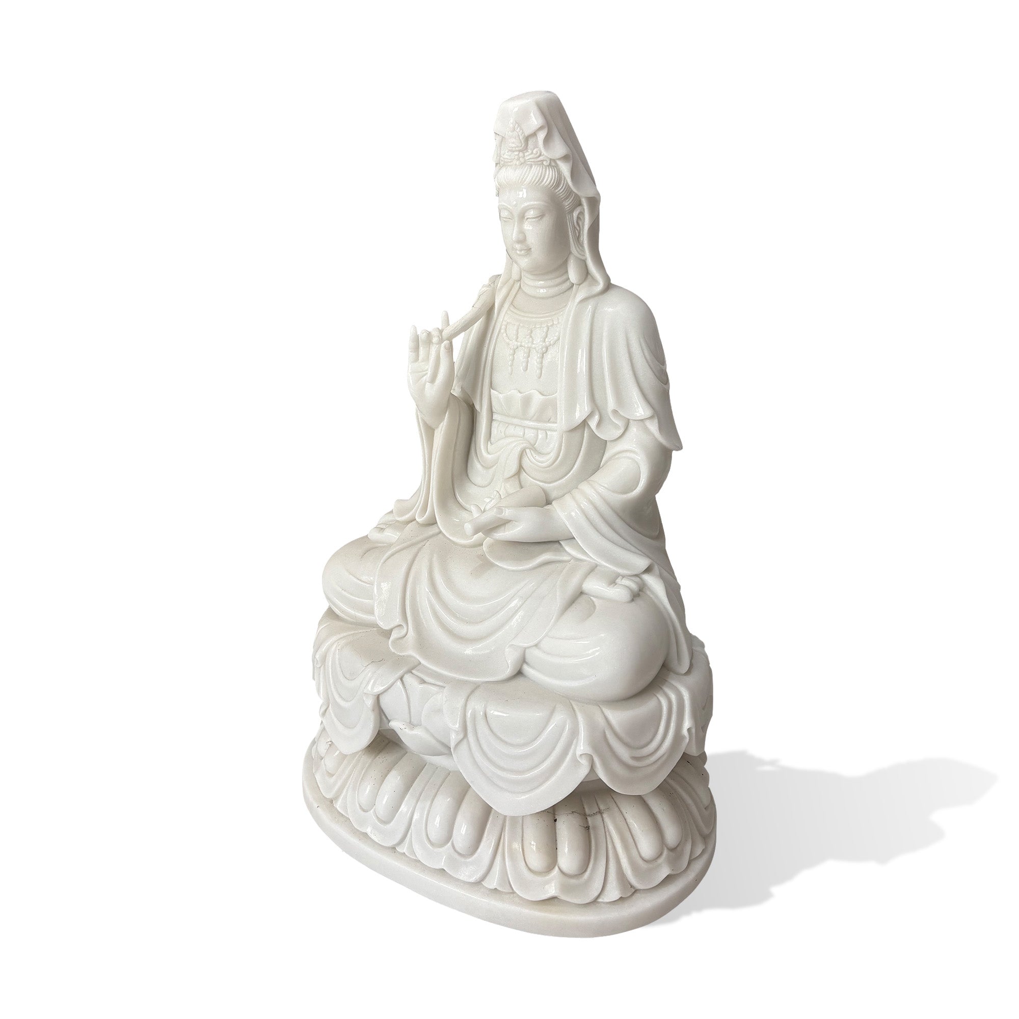 Side view of a white marble Guanyin Bodhisattva sculpture with lotus seat, raised botanical branch, detailed jewelry, and draped robes