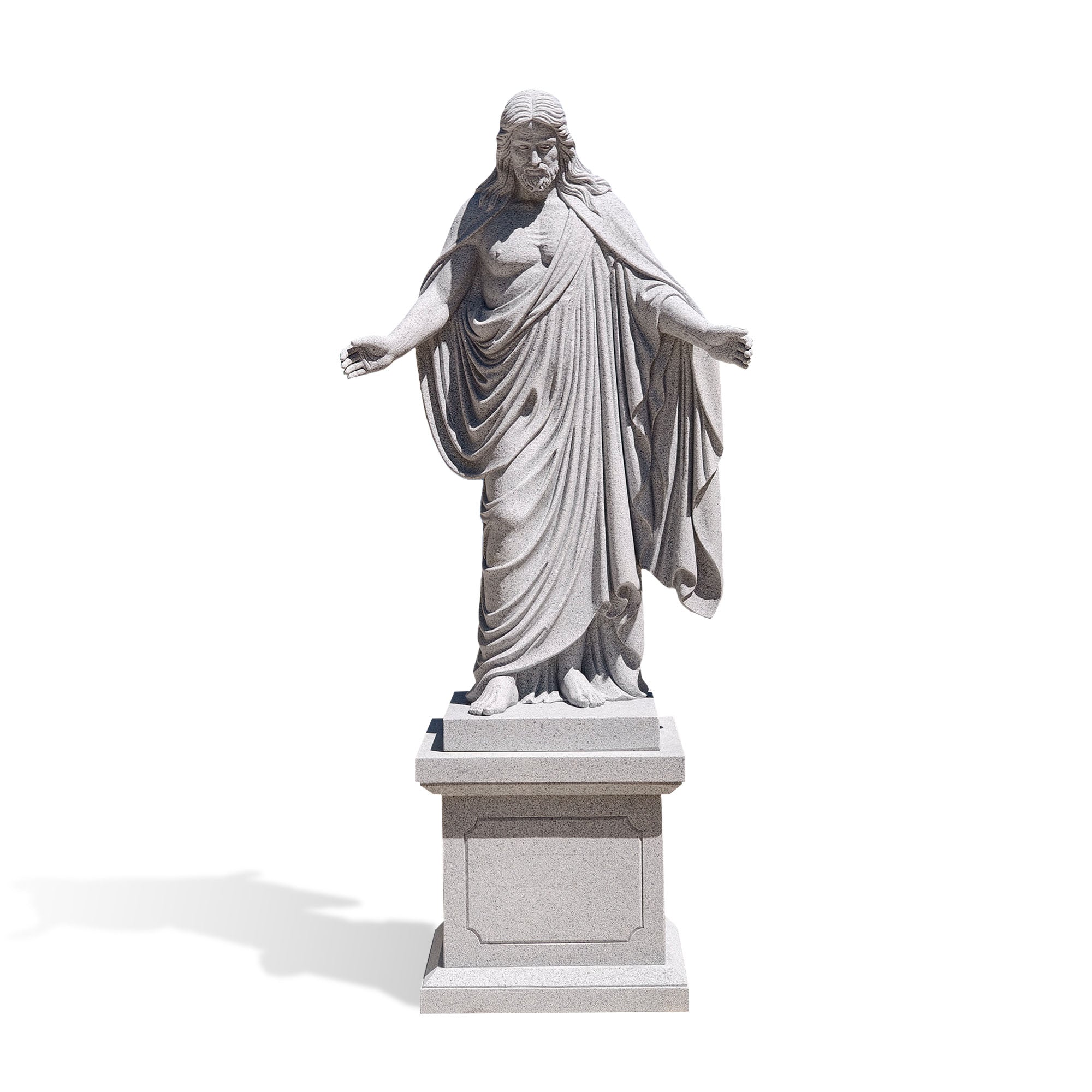 Front view of a hand carved natural grey granite Christ the Redeemer statue with open arms on a stone pedestal.