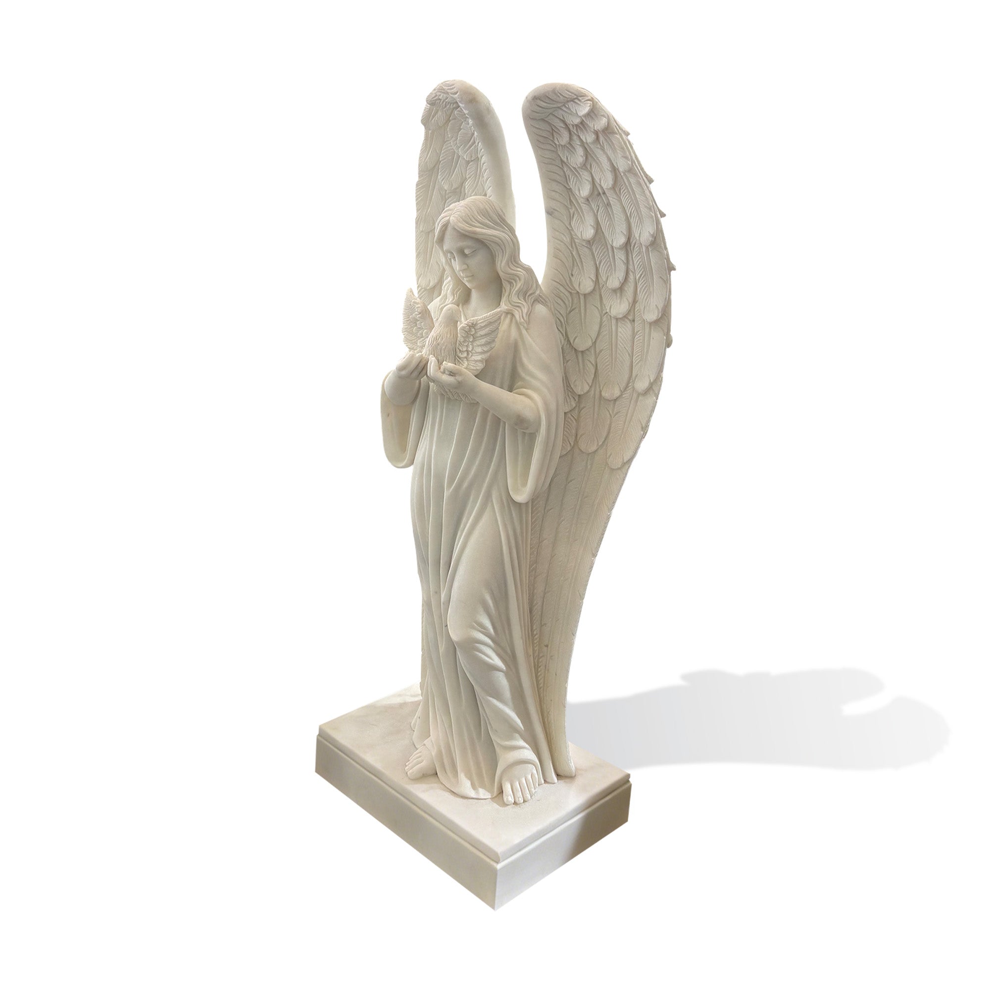 Side view of a hand-carved white marble guardian angel sculpture holding a dove, showcasing elegant flowing robes, graceful posture, and finely carved feathered wings.