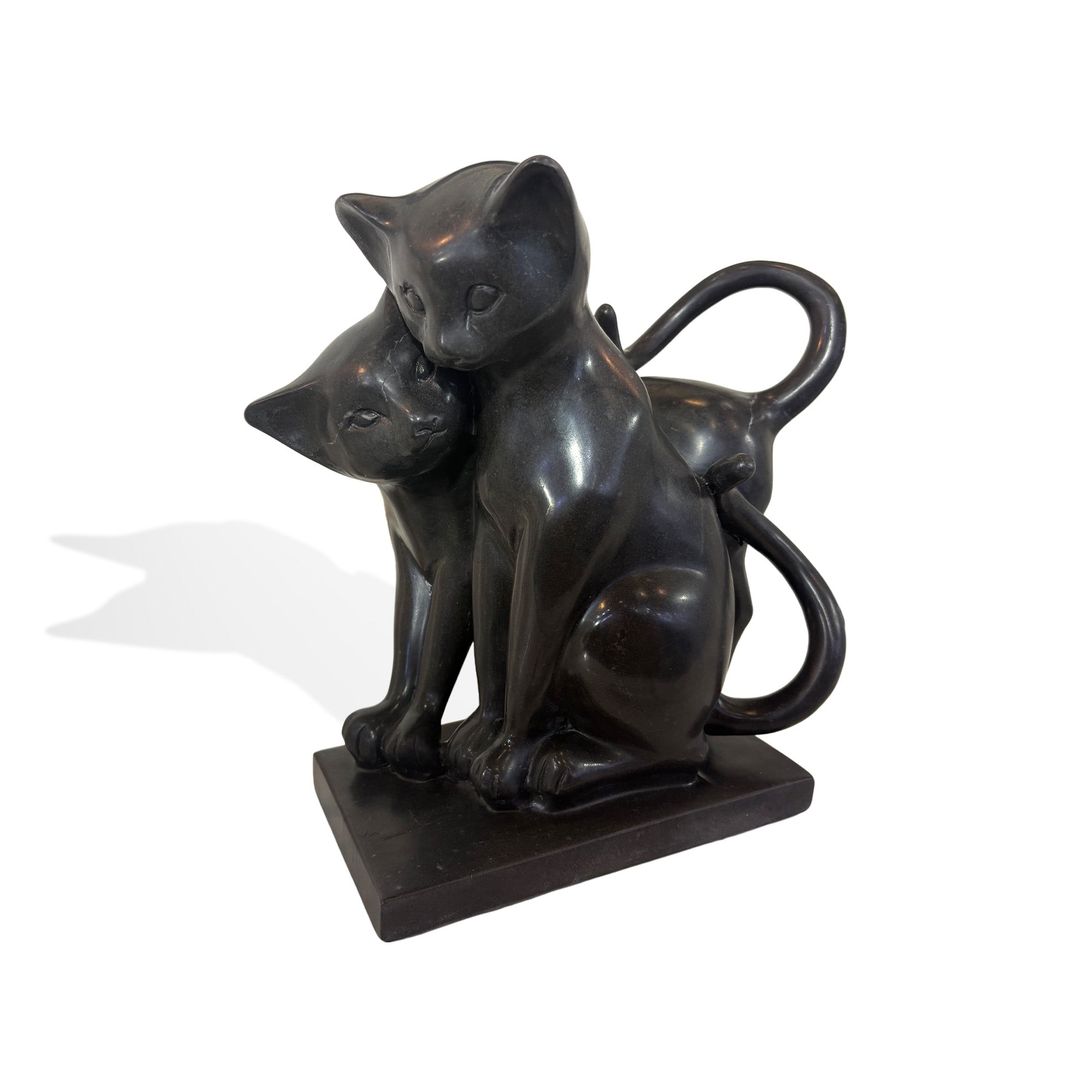 Two black stone cats cuddling together on a square base, designed as warm and playful home decor for cat lovers