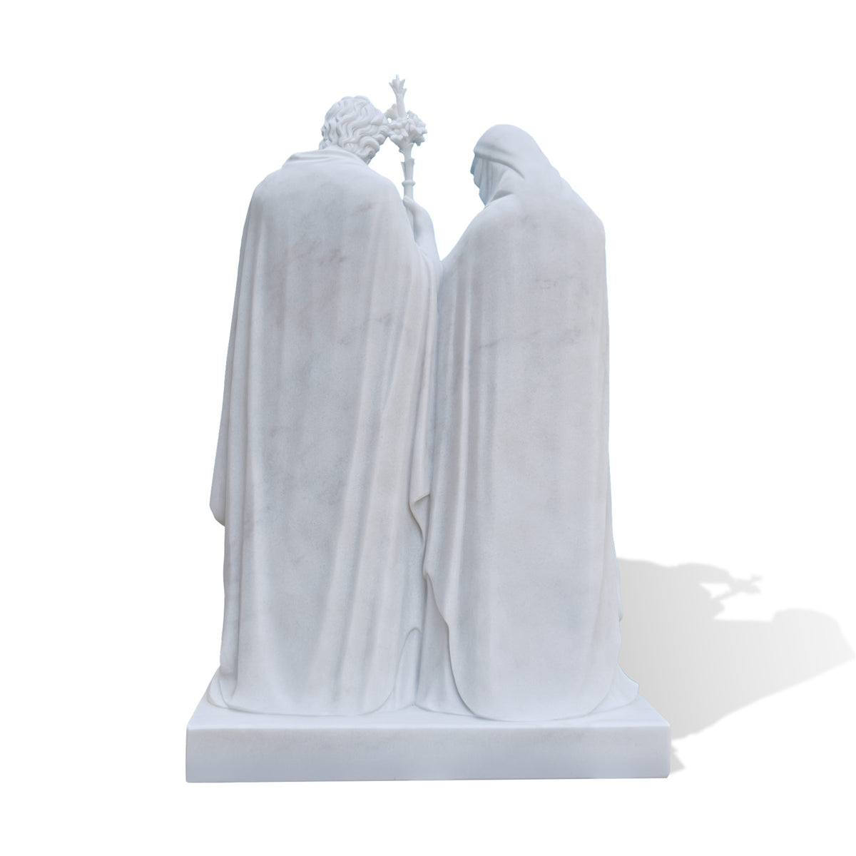 Back view of a white marble Holy Family sculpture showing the full-length flowing cloaks of the Virgin Mary and Saint Joseph, detailed natural stone texture, and rectangular marble base.