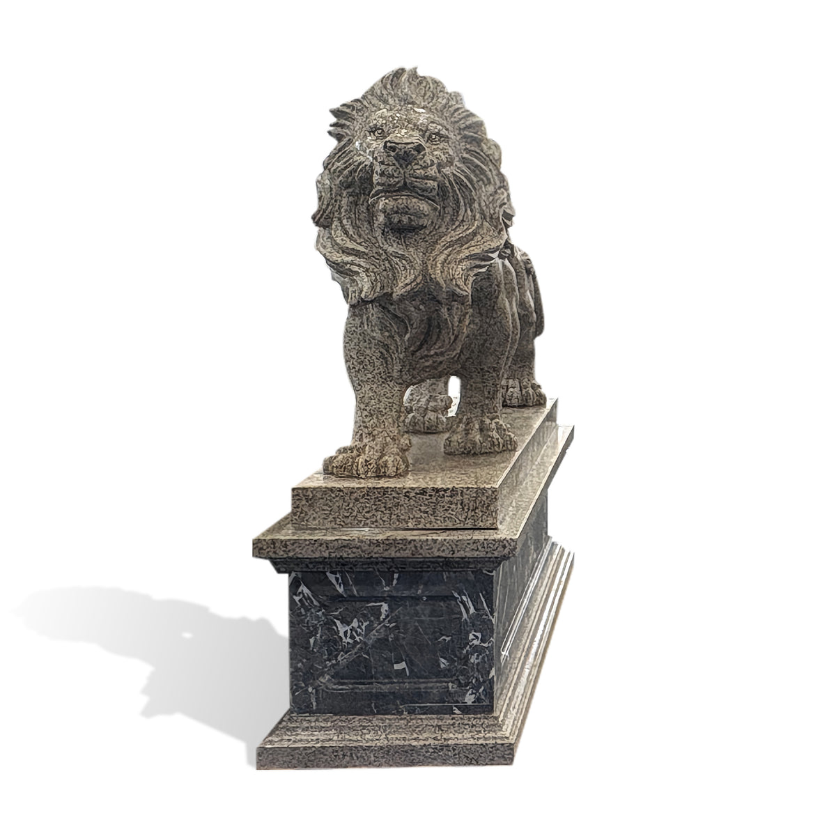 Front view of a carved stone lion statue with a majestic mane, powerful stance and rectangular stone pedestal with natural veining.