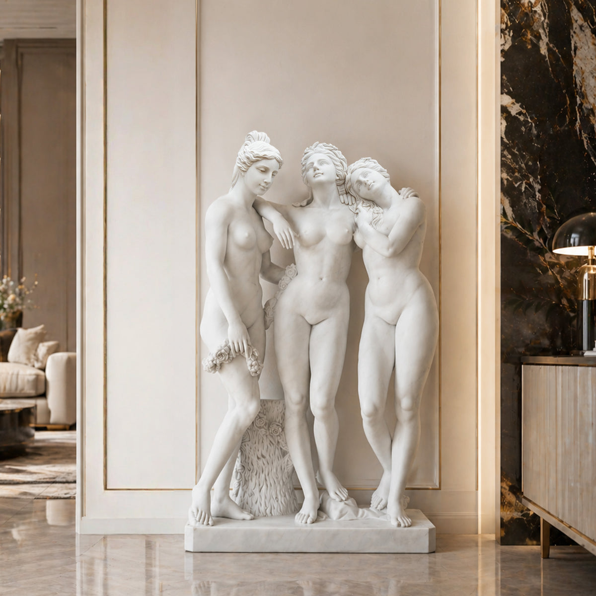 White marble Three Graces statue replica displayed in a luxury villa interior with classical wall paneling, polished stone floors and elegant furnishings.