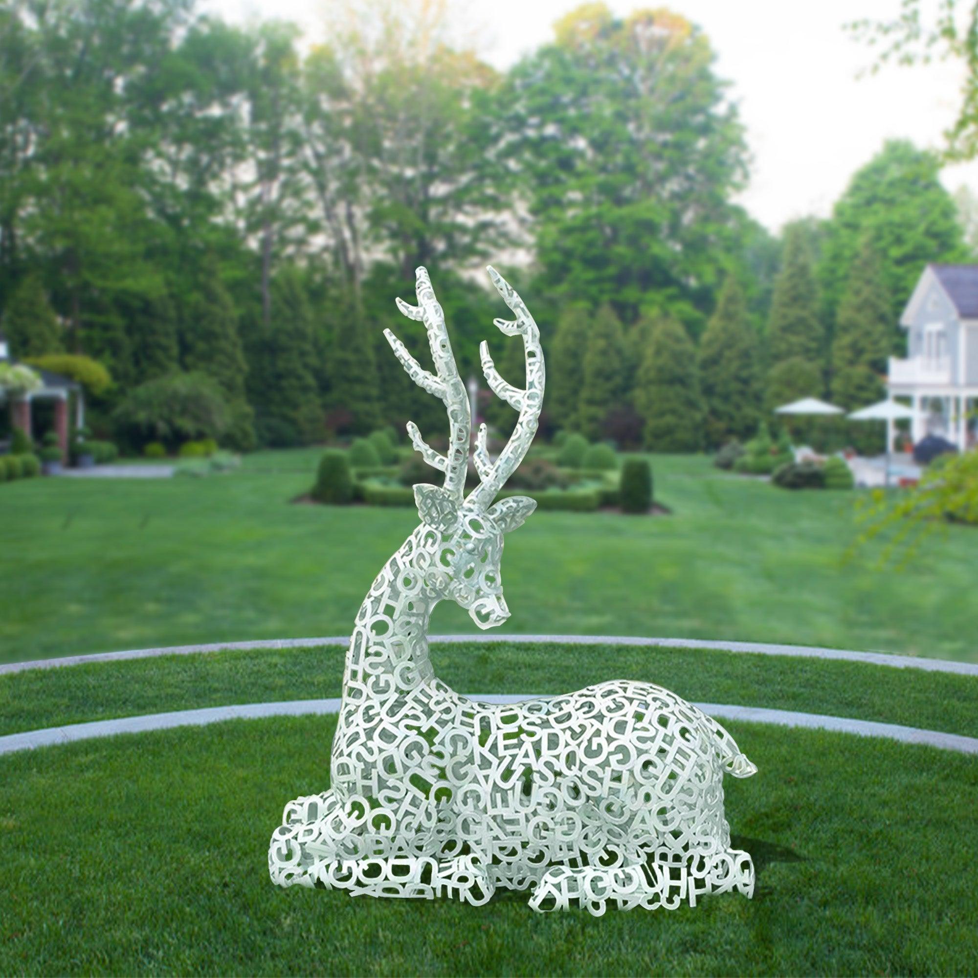 Hollow Letter White Elk Outdoor Metal Sculpture set against a lush green garden backdrop