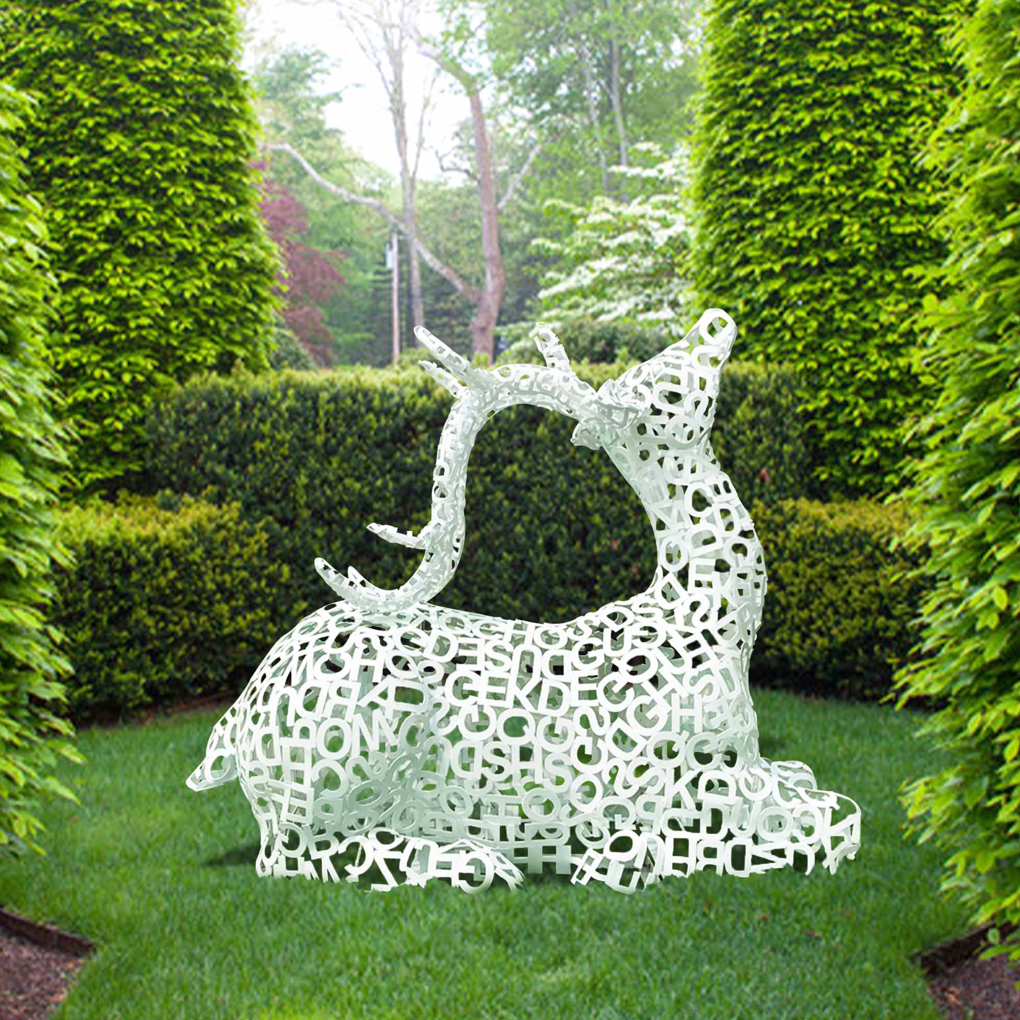 white letter metal elk sculpture lying in a green garden raise its head