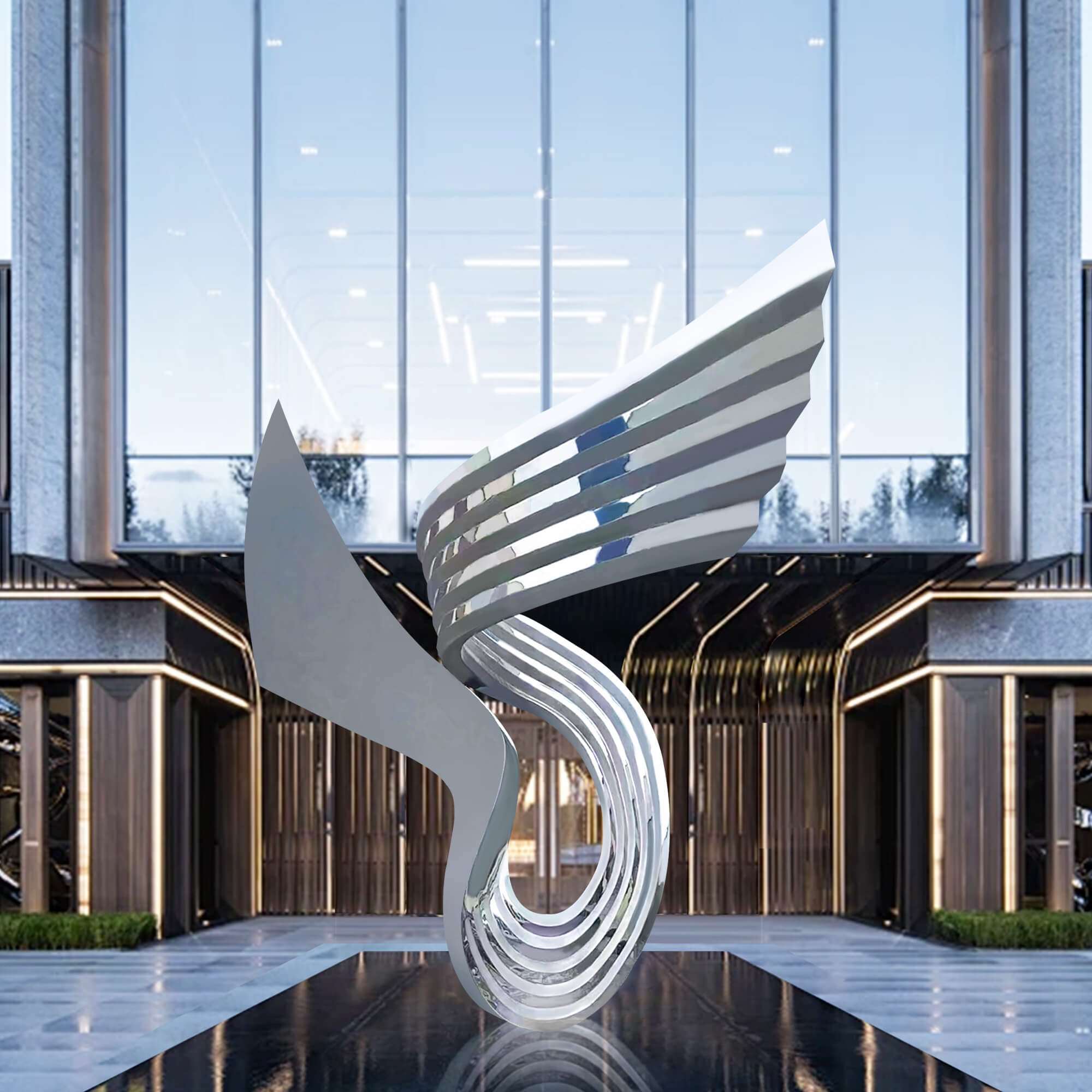 An abstract stainless steel sculpture with flowing, curved layers stands prominently in front of a modern building with tall glass windows