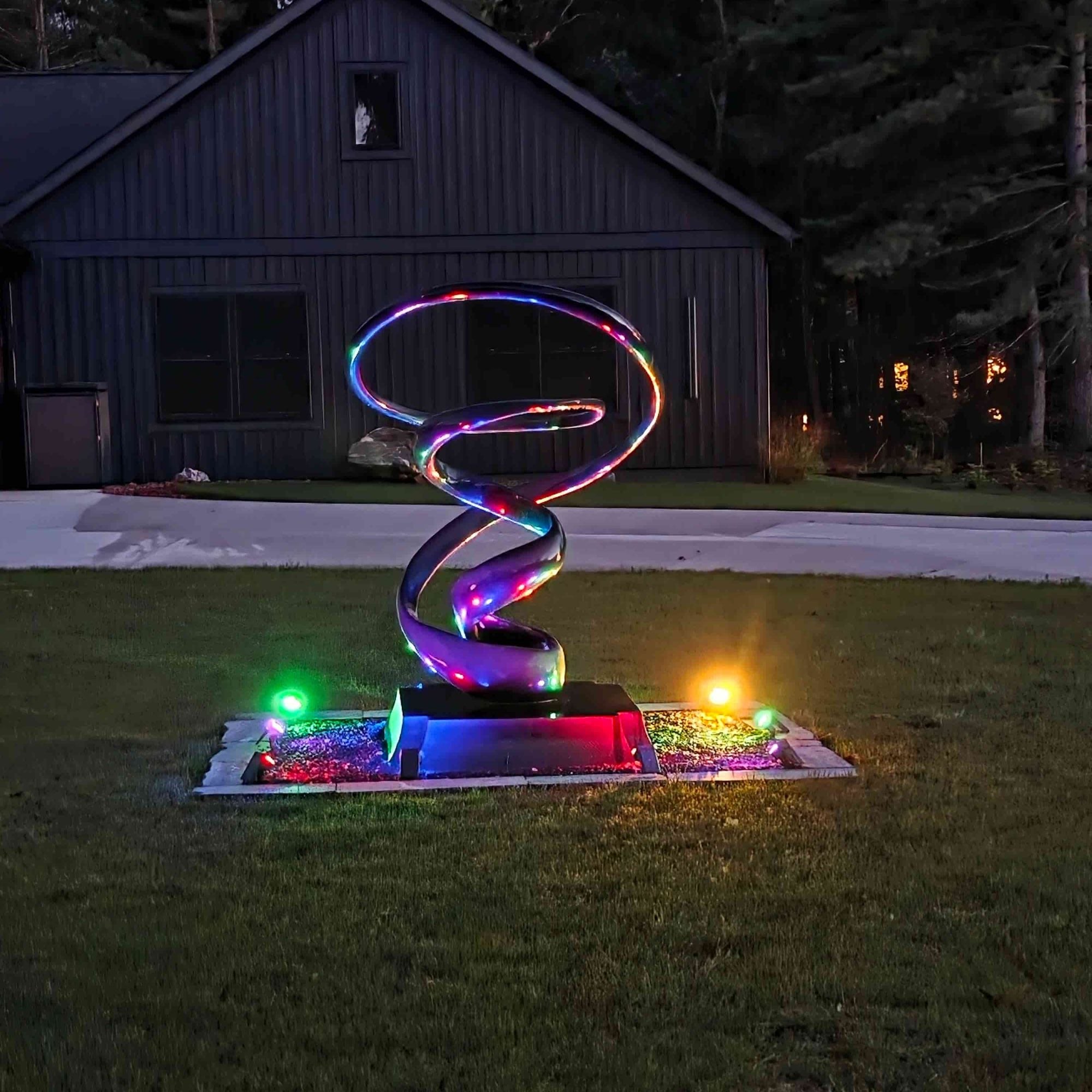 modern abstract led light sculpture displayed in front yard garden muskegon michigan united states