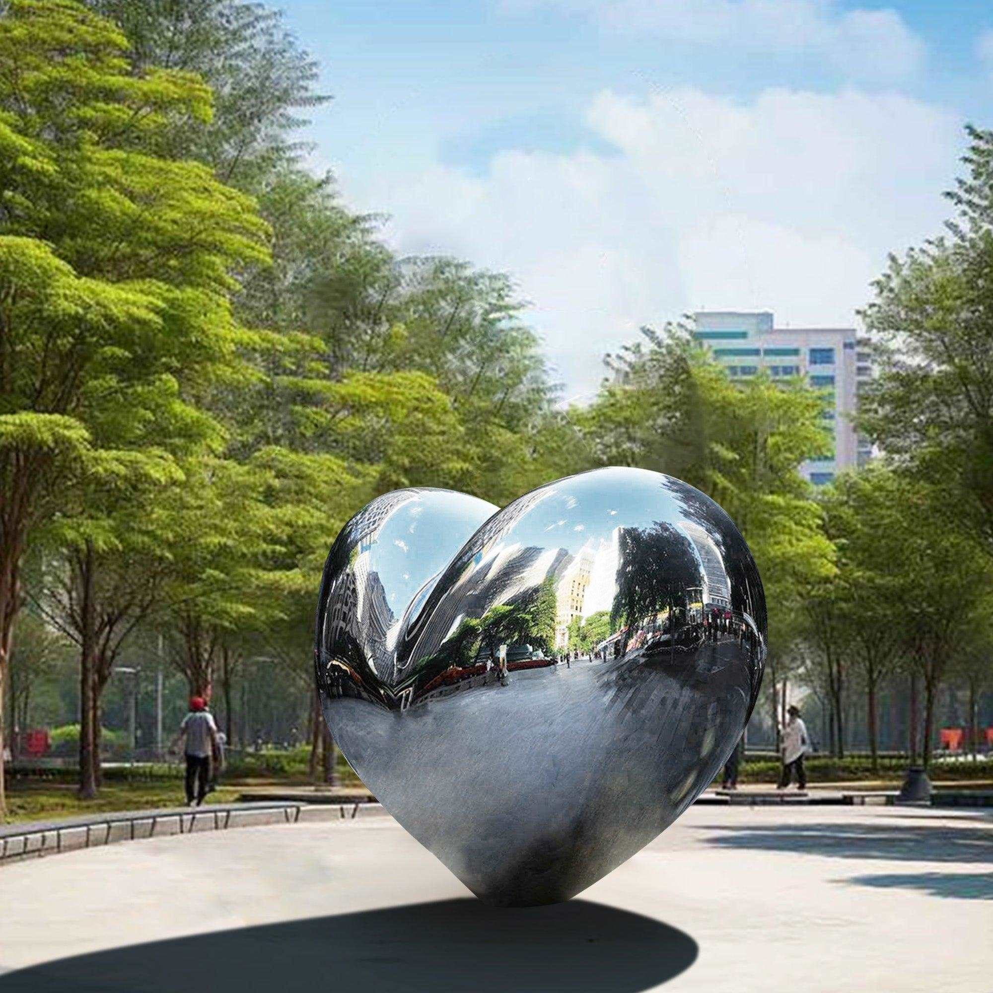 large love heart mirror finish metal sculpture placing in a public garden