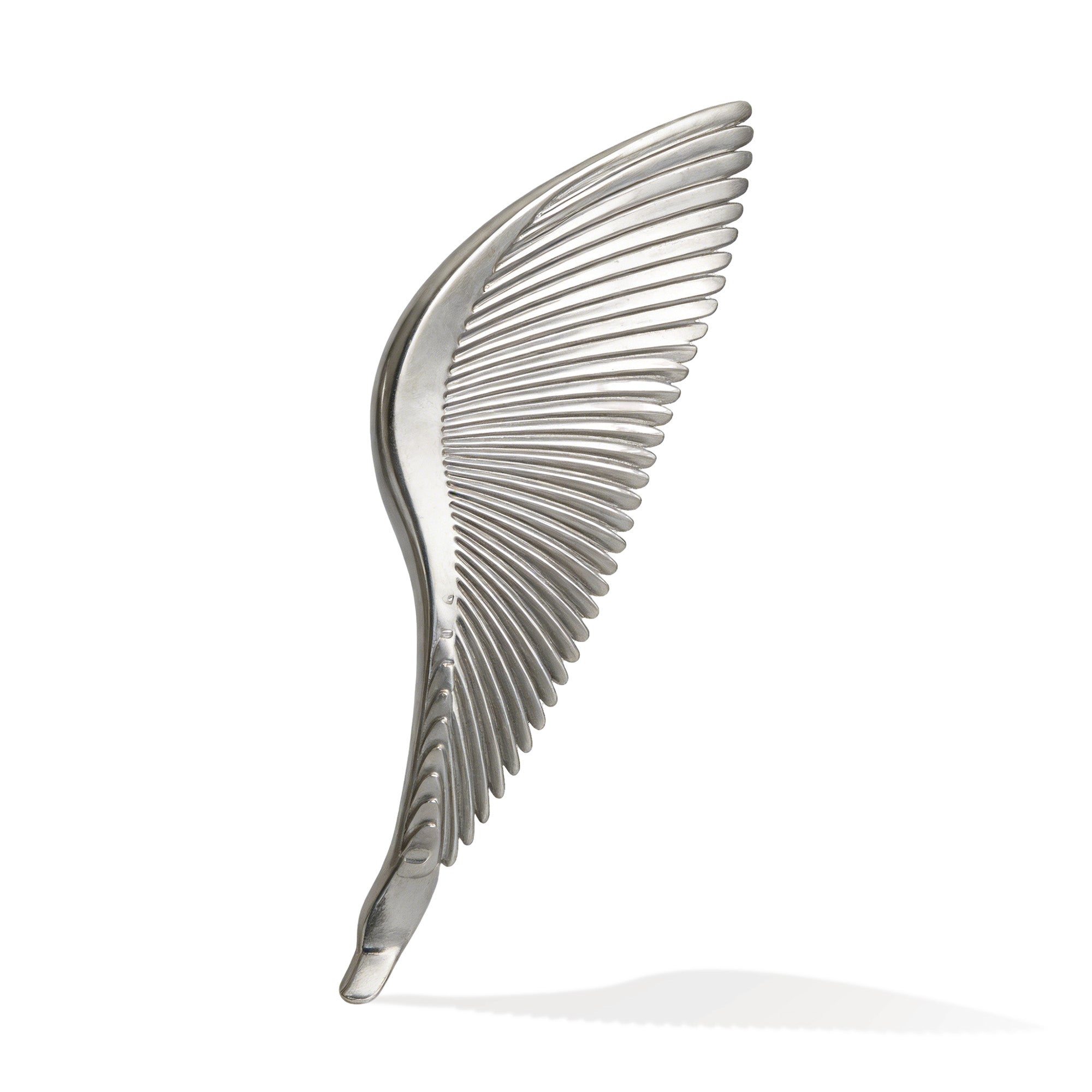 Metallic wing-shaped object on a white background