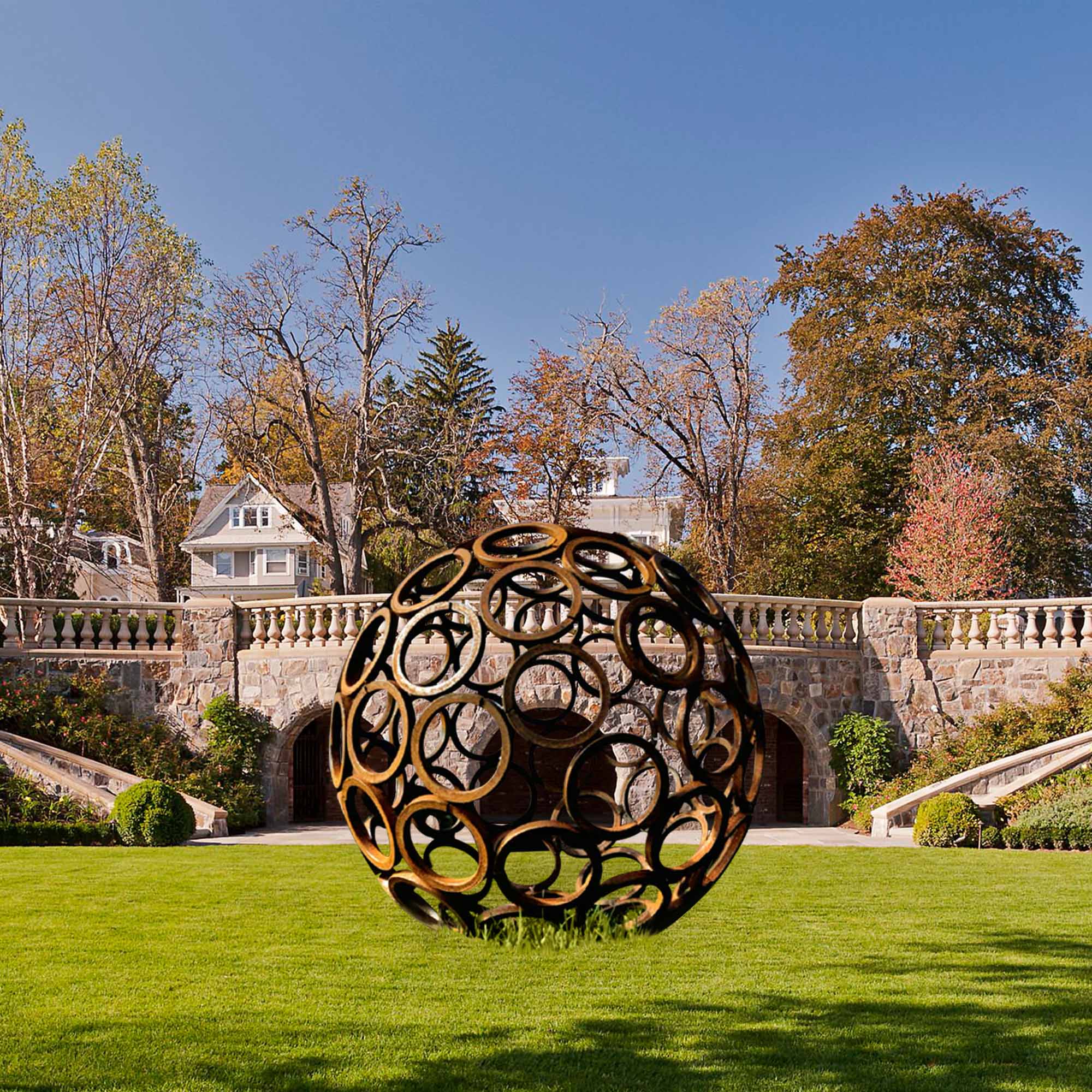 large size hollow sphere corten steel garden sculpture on the lawn