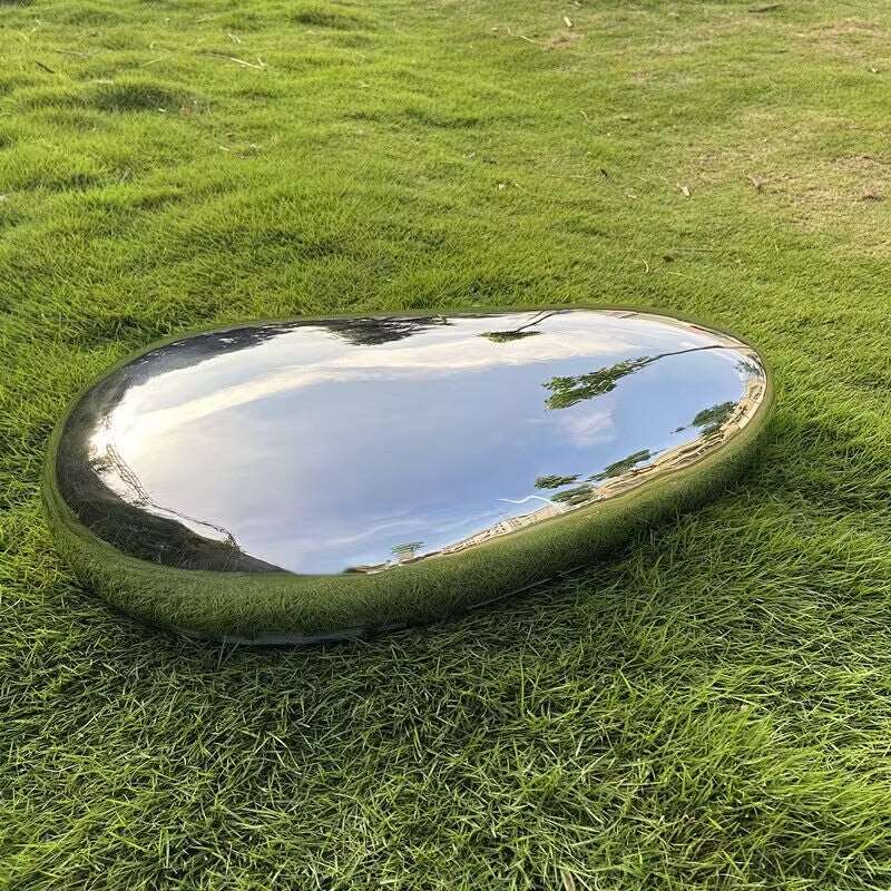 mirror polished stainless steel cobblestone sculpture on the lawn