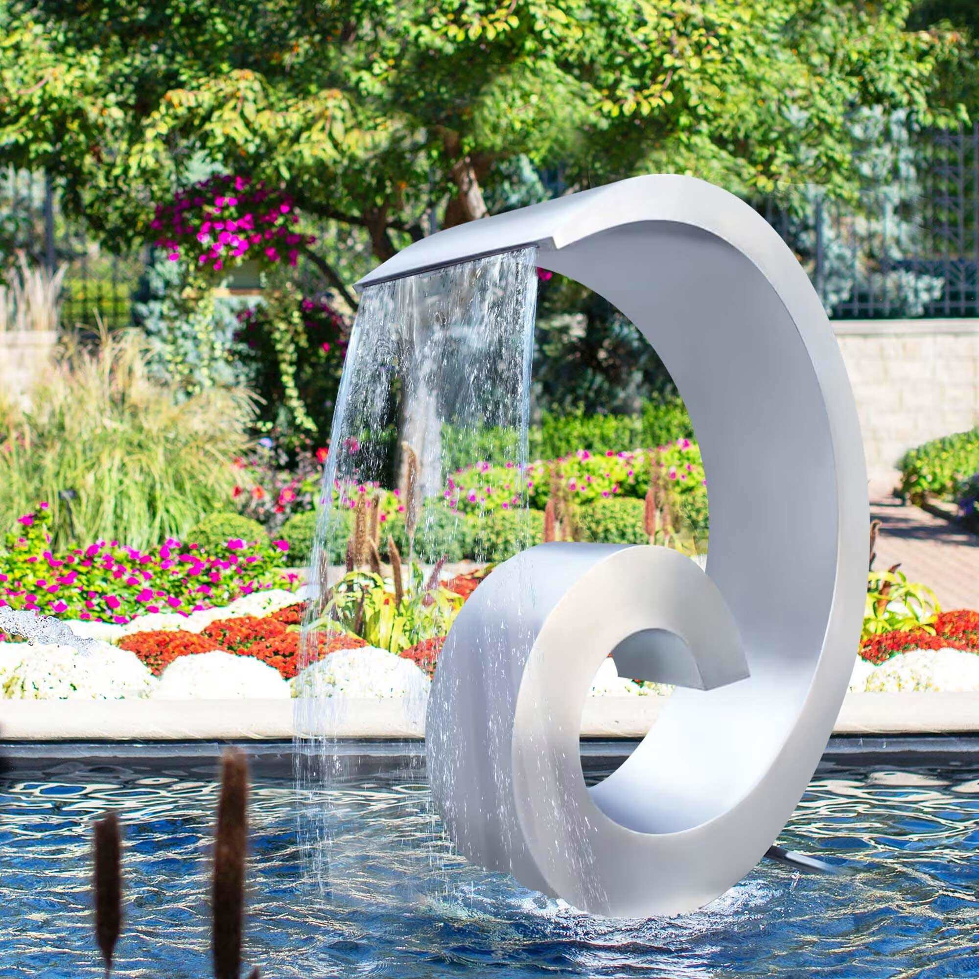 Stainless steel water fountain sculpture with a spiral design and brushed satin finish, featuring cascading water in an outdoor setting