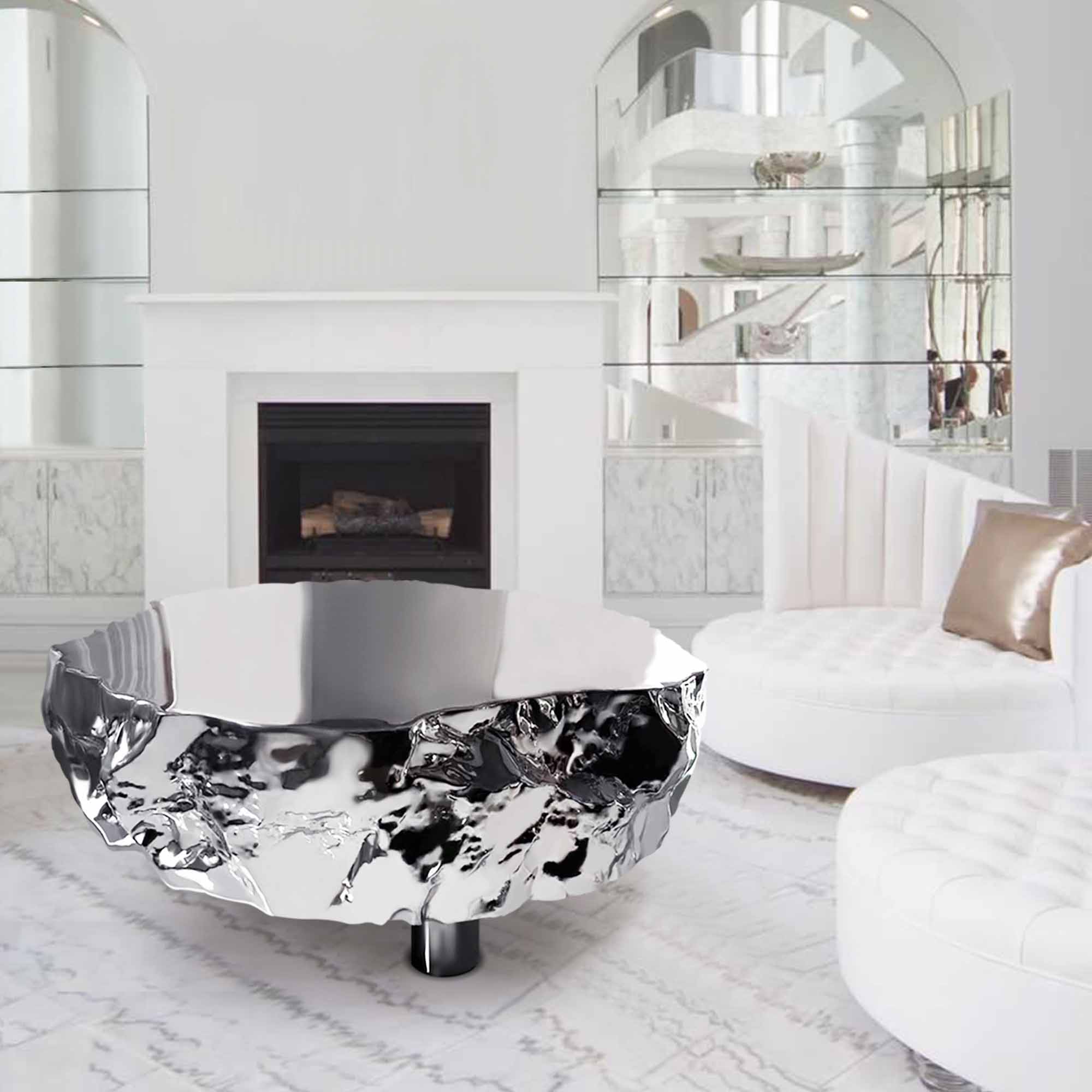 Modern stainless steel coffee table with a polished mirror surface and textured base, placed in a luxury living room setting