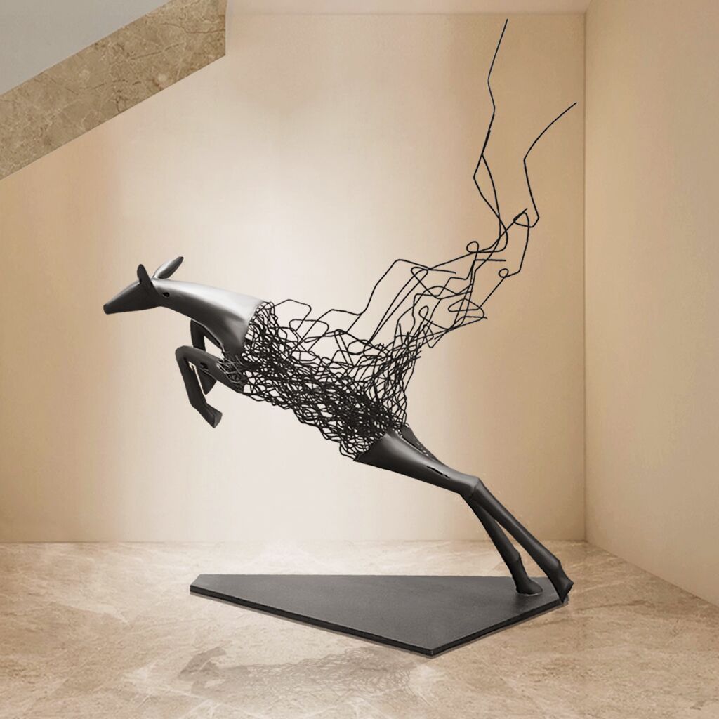 Abstract metal floor sculpture of a deer with fragmented design in glossy black and matte white dislpay indoor lobby