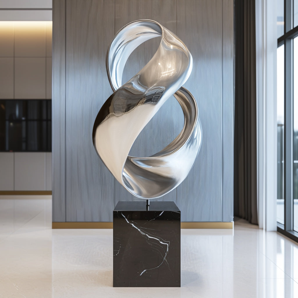 Contemporary indoor modern abstract infinity stainless steel sculpture with polished finish and black base display indoor lobby