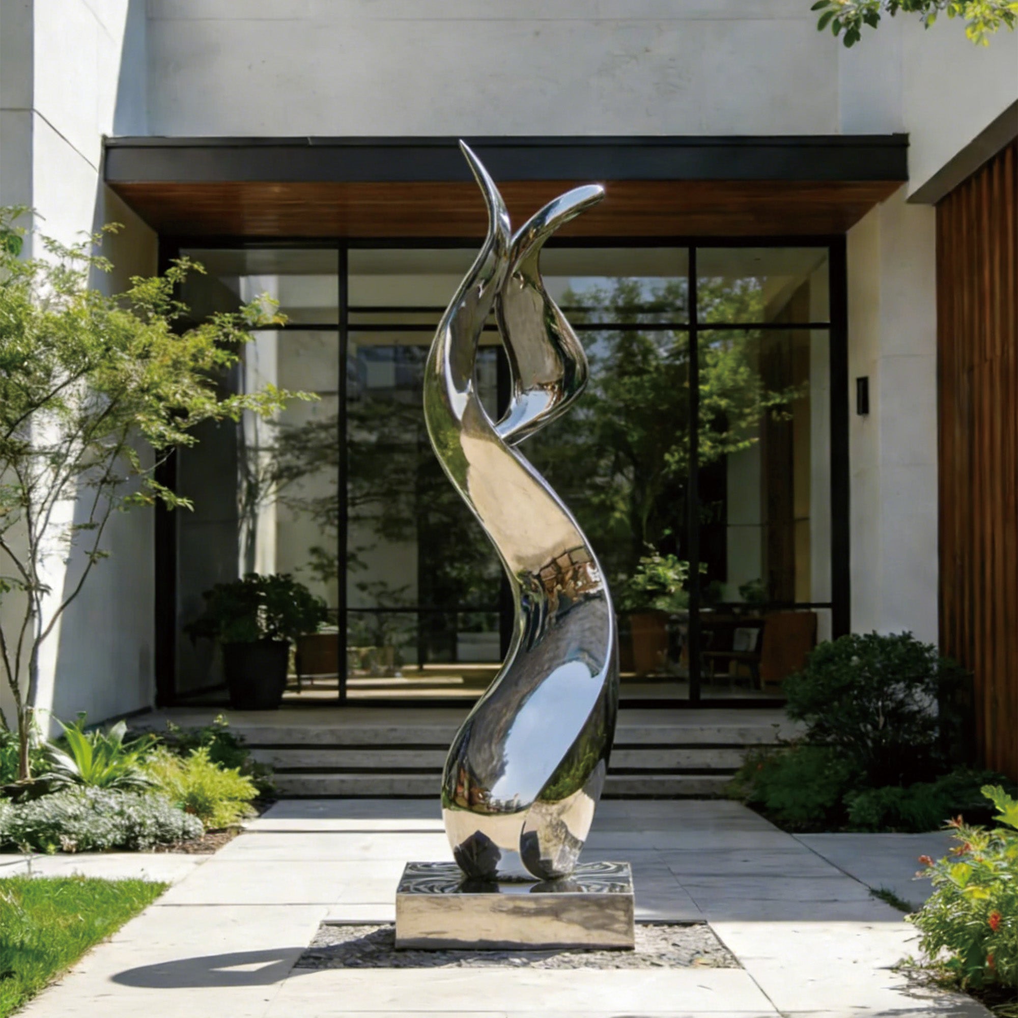 Modern stainless steel abstract sculpture with mirror finish placed at an outdoor entryway, viewed from the front to highlight its sleek, polished surface and sophisticated design