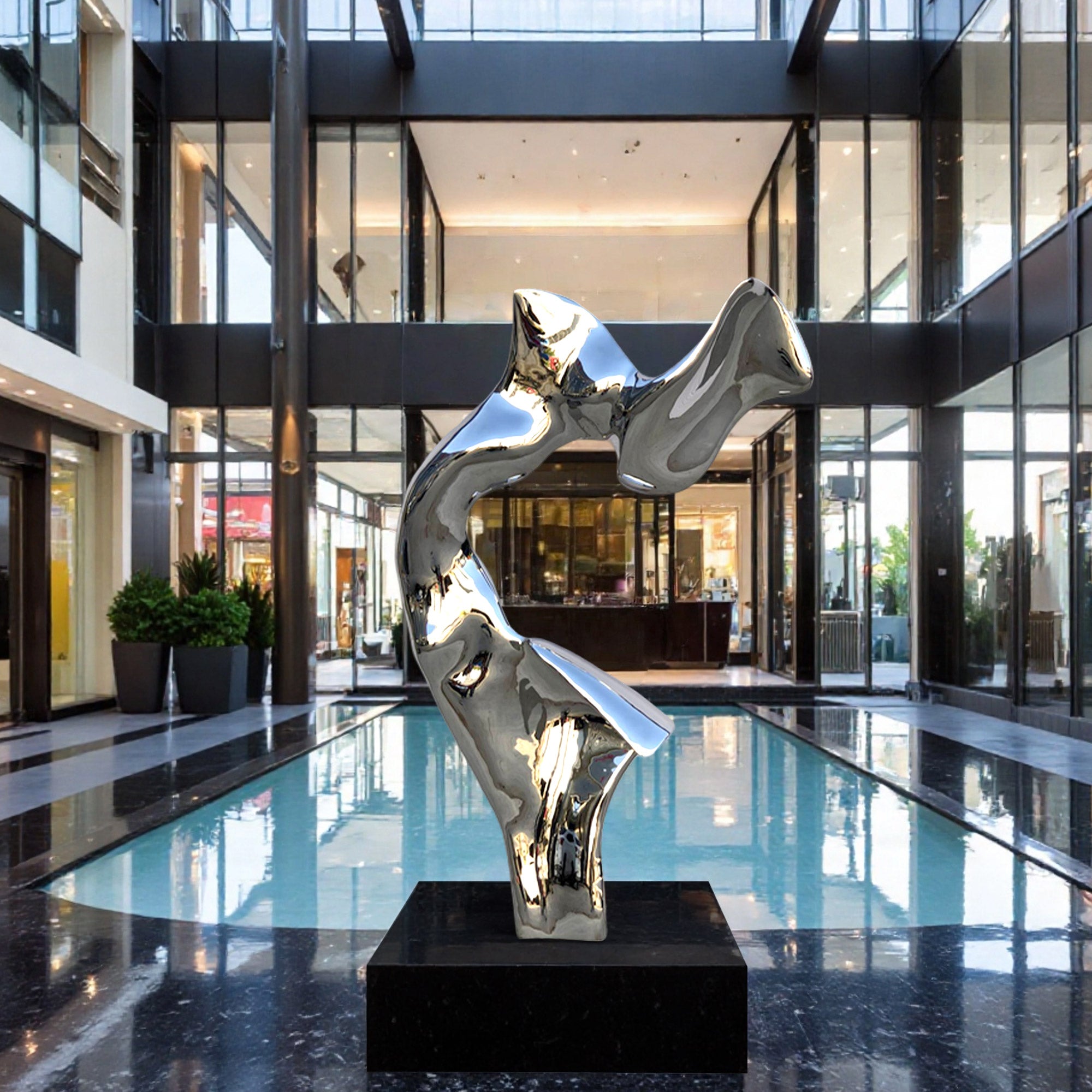 Modern sculpture in a sleek building interior with reflective floor