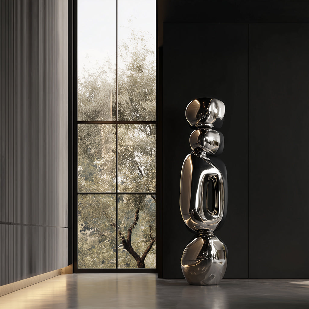 Modern stainless steel sculpture in a room with large windows