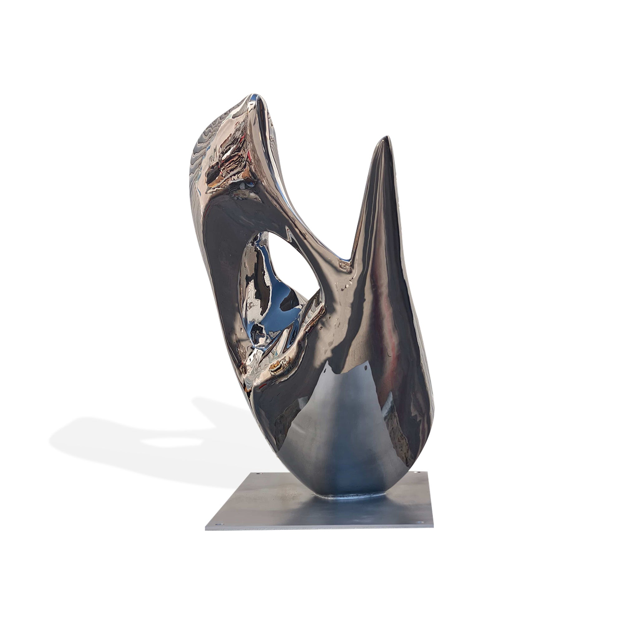stainless steel fluid form sculpture, with shiny mirror finish reflecting the natural landscape and architectural elements