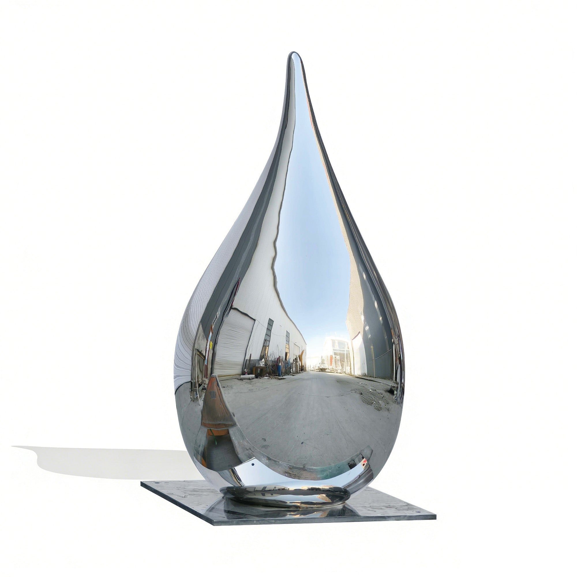 A modern stainless steel drop-shaped sculpture standing tall, enhancing the outdoor space with its reflective surface.