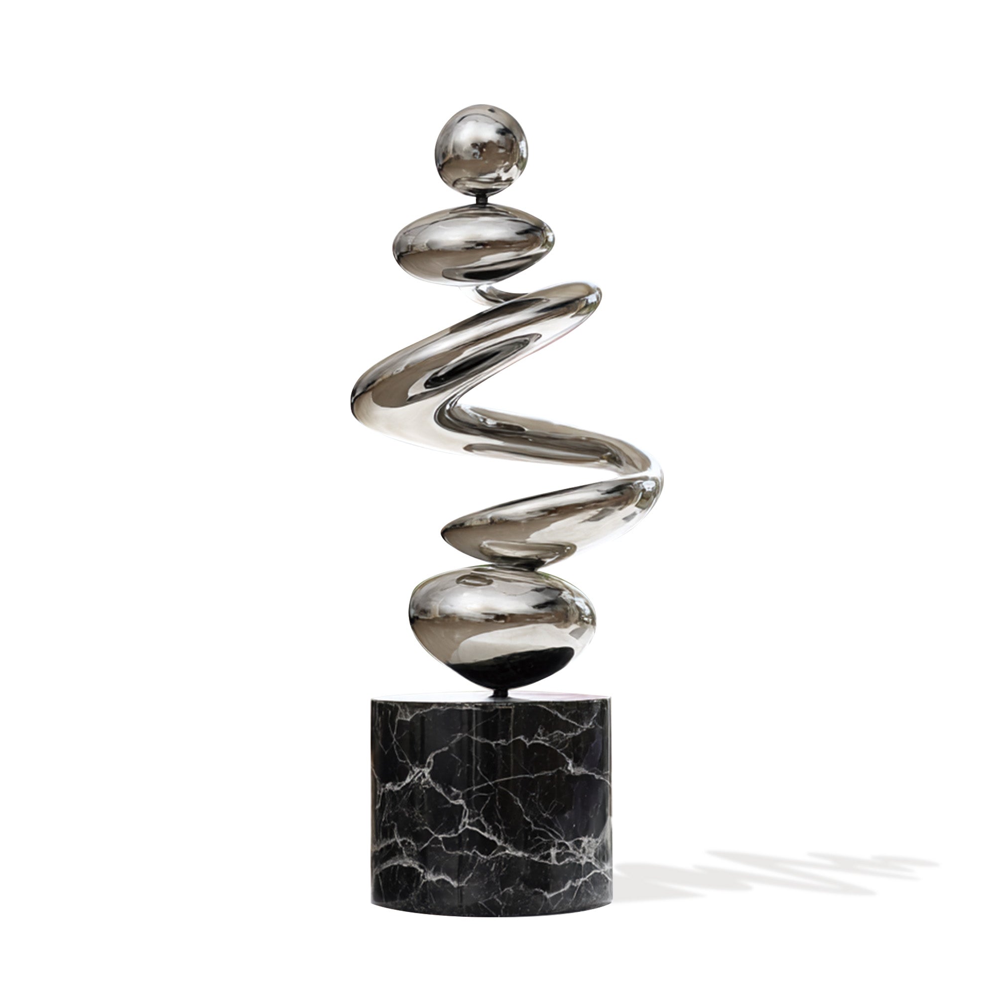 Spiral metal sculpture on a black marble base against a white background