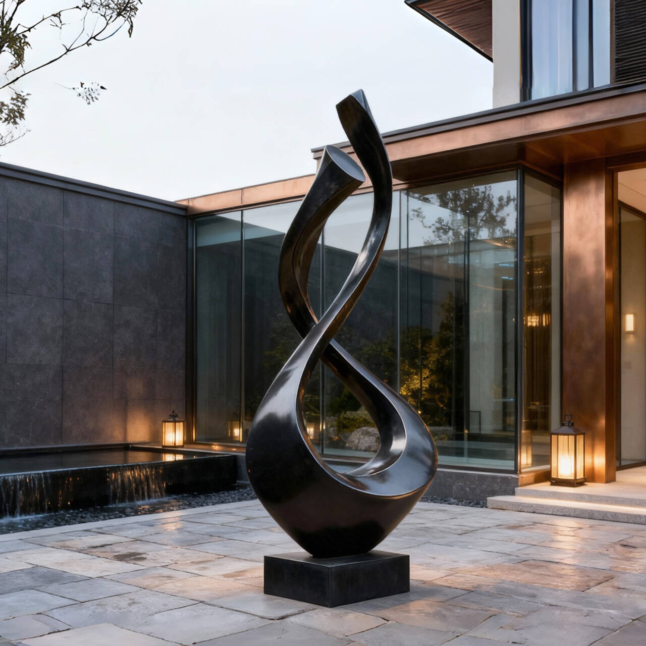 Black Abstract sculpture in front of a modern building with glass walls